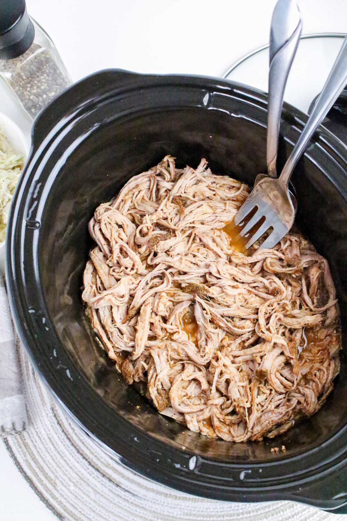 Pulled pork tenderloin slow cooked in a crock pot.