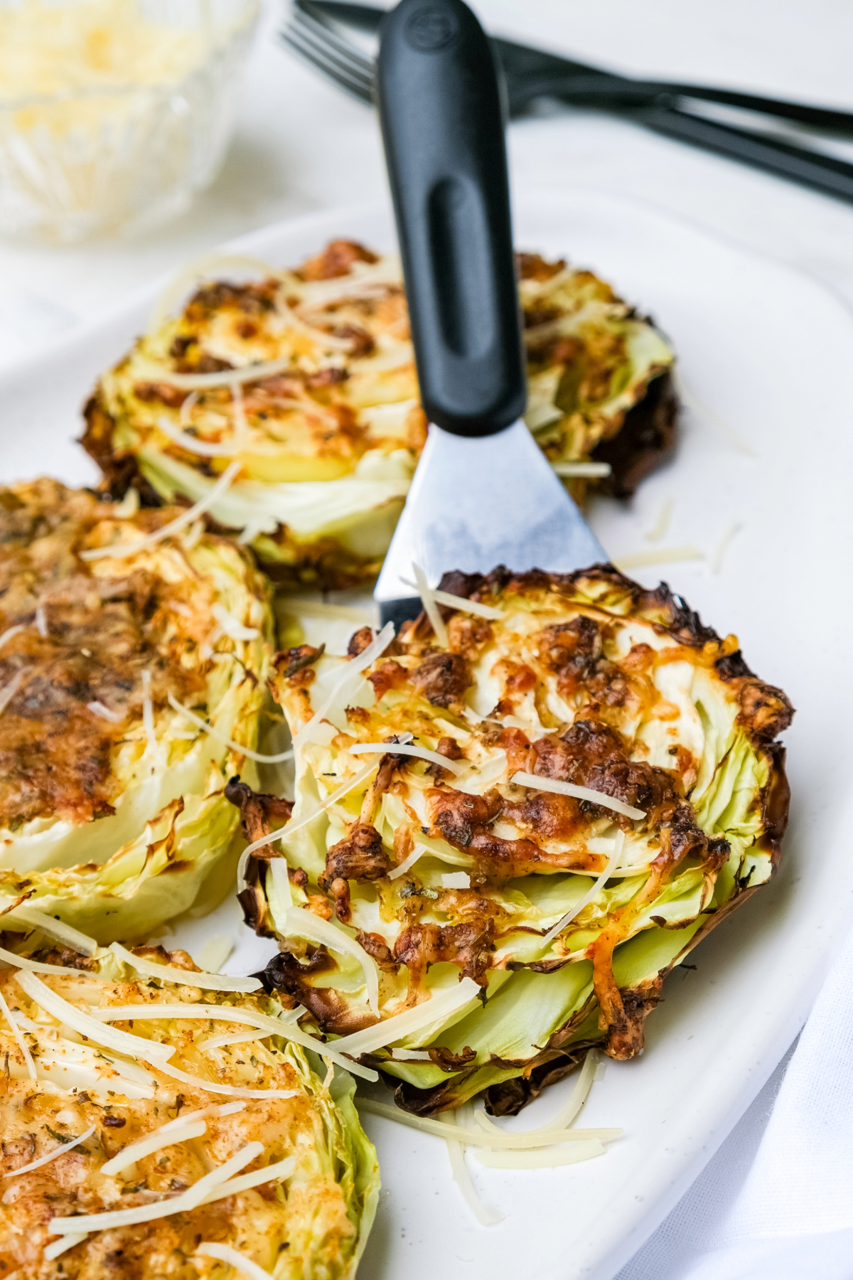 Serving with a spatula sliced cabbage steaks.