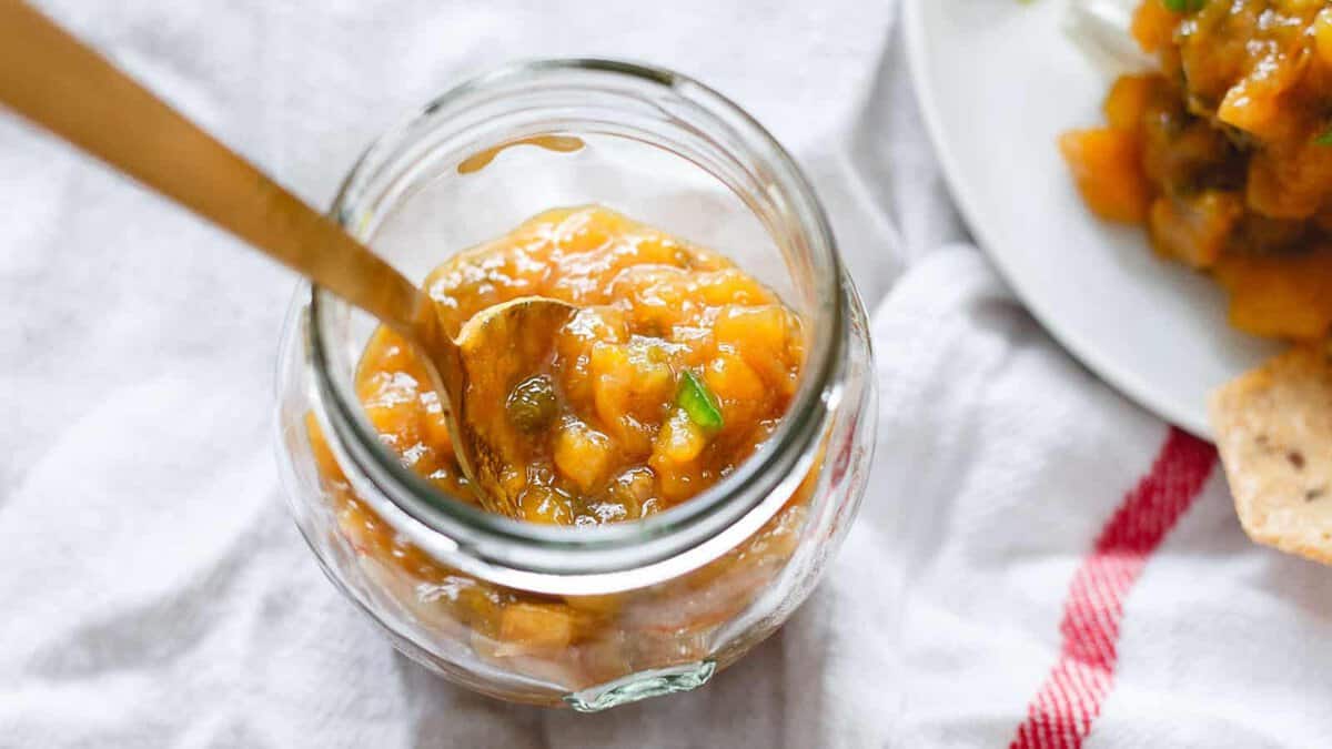 Jalapeno mango jam in a glass jar.
