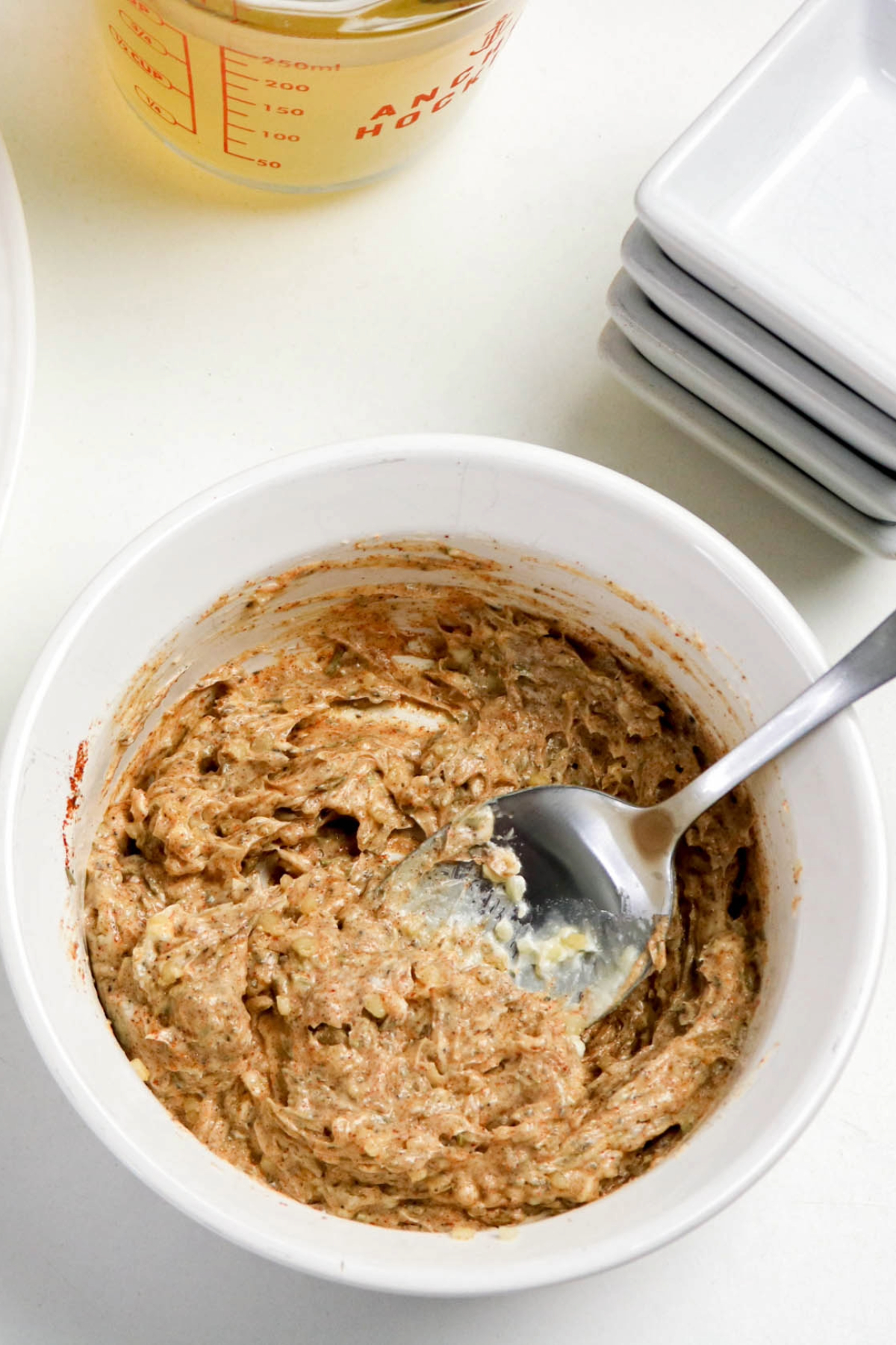 Butter and herb mixture in a small white mixing bowl.