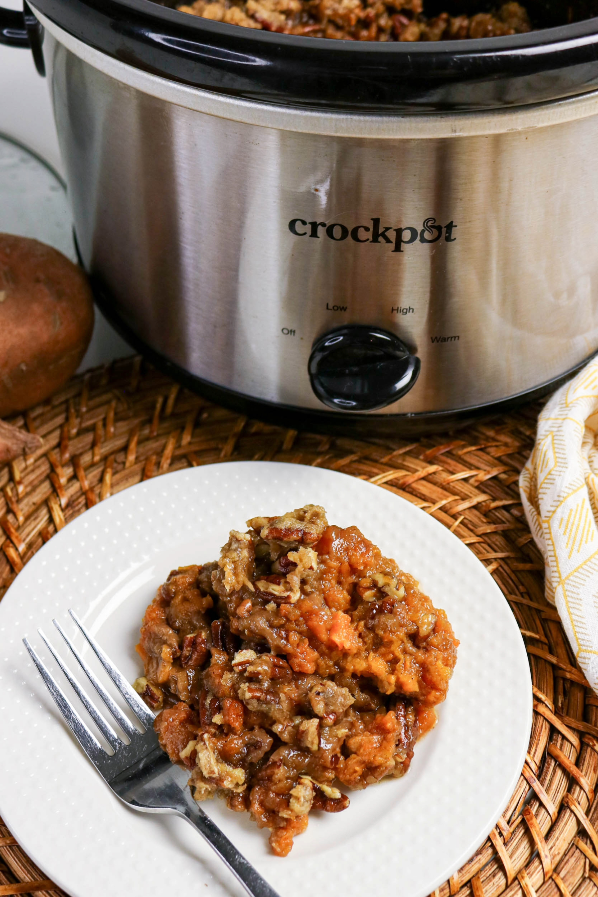sweet potato casserole with crock pot in the background.