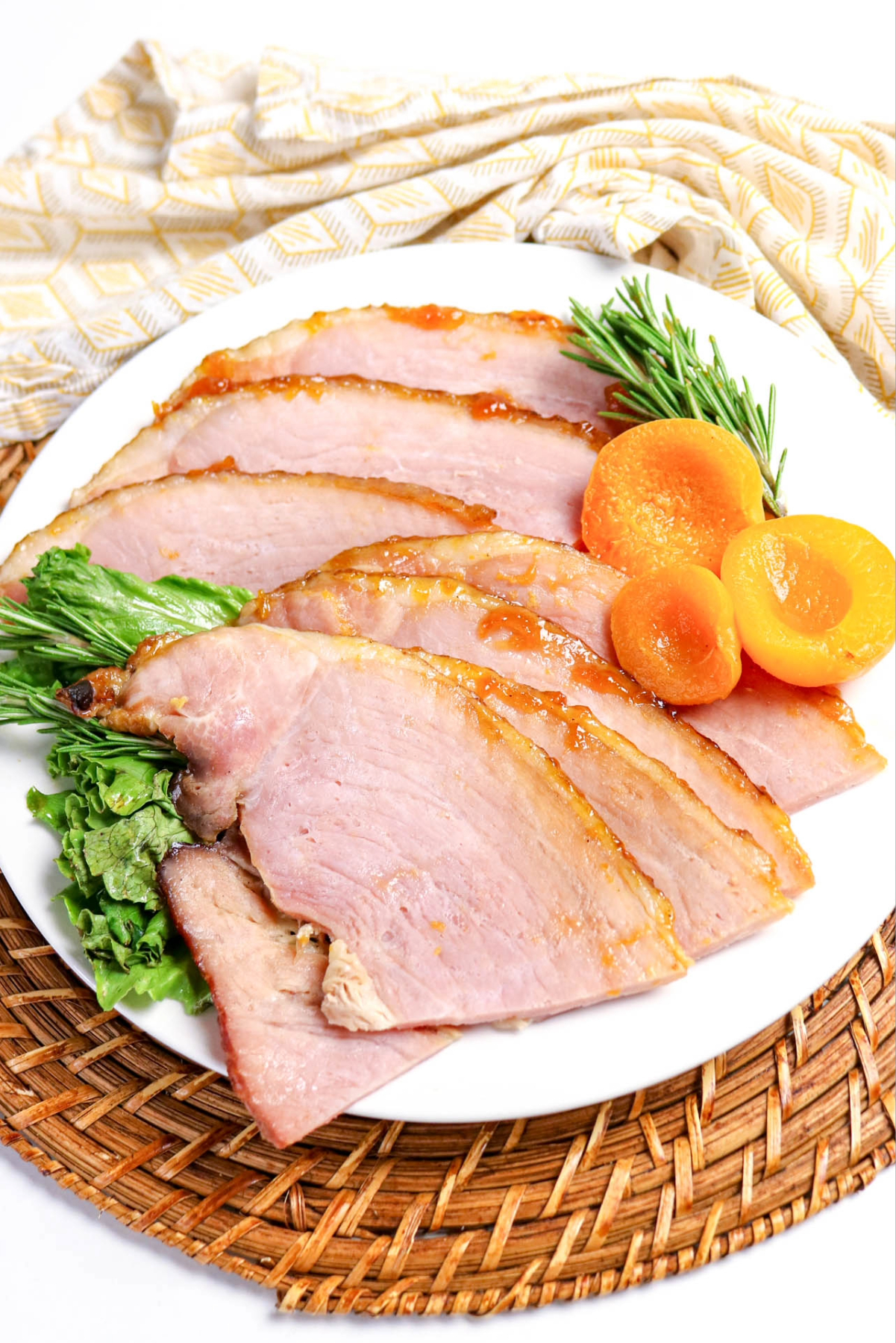 Slices of ham on a white dinner plate.