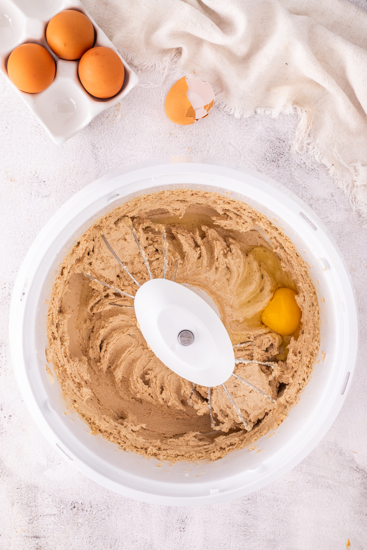 Eggs added to wet cake batter mix.