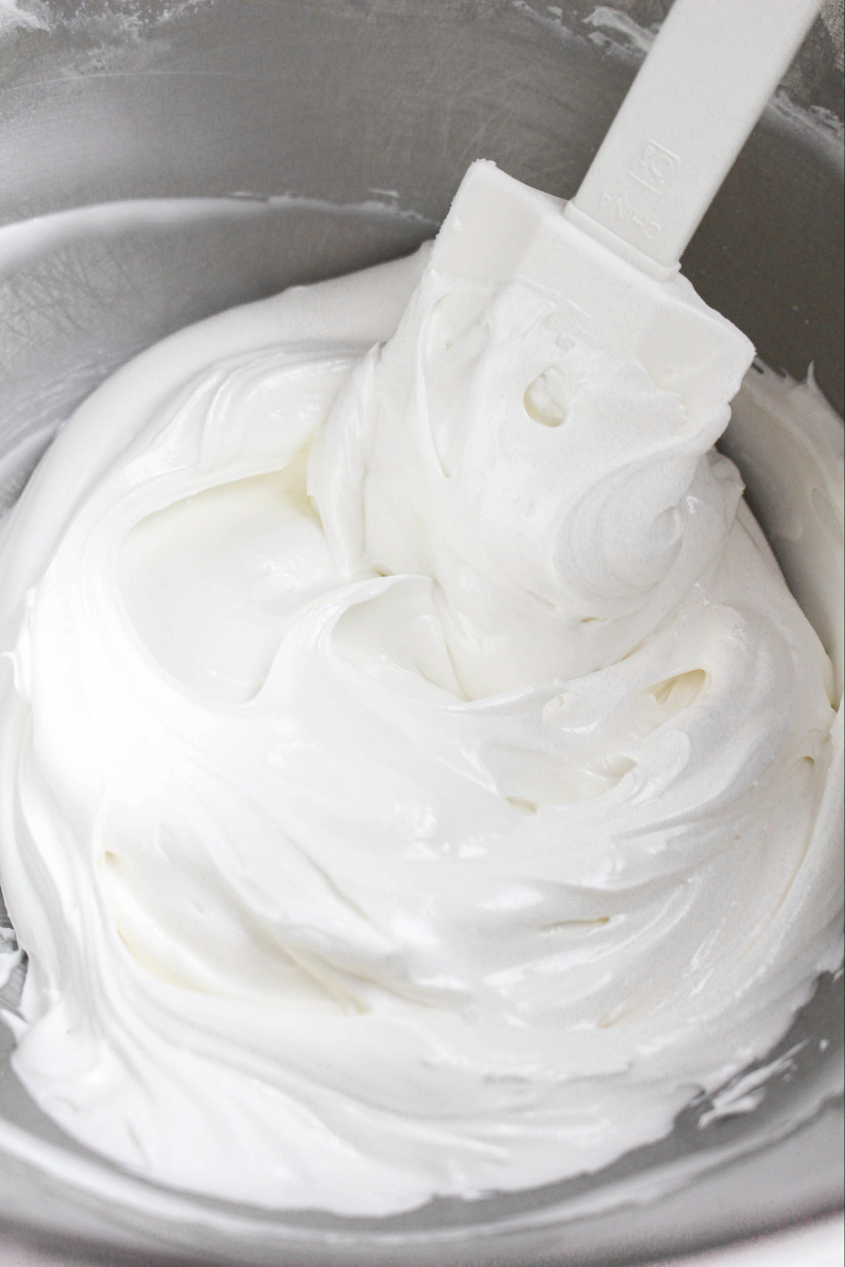 whipped royal icing in a stand mixing bowl.