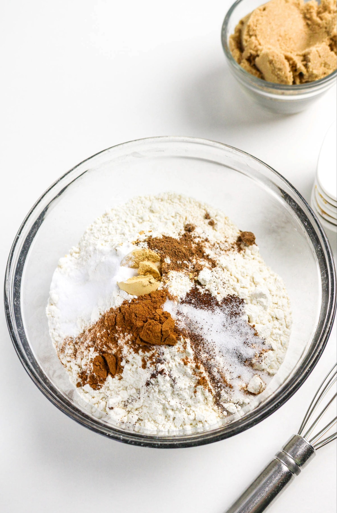 Flour and spices in a cler mixing bowl for cookie dough.