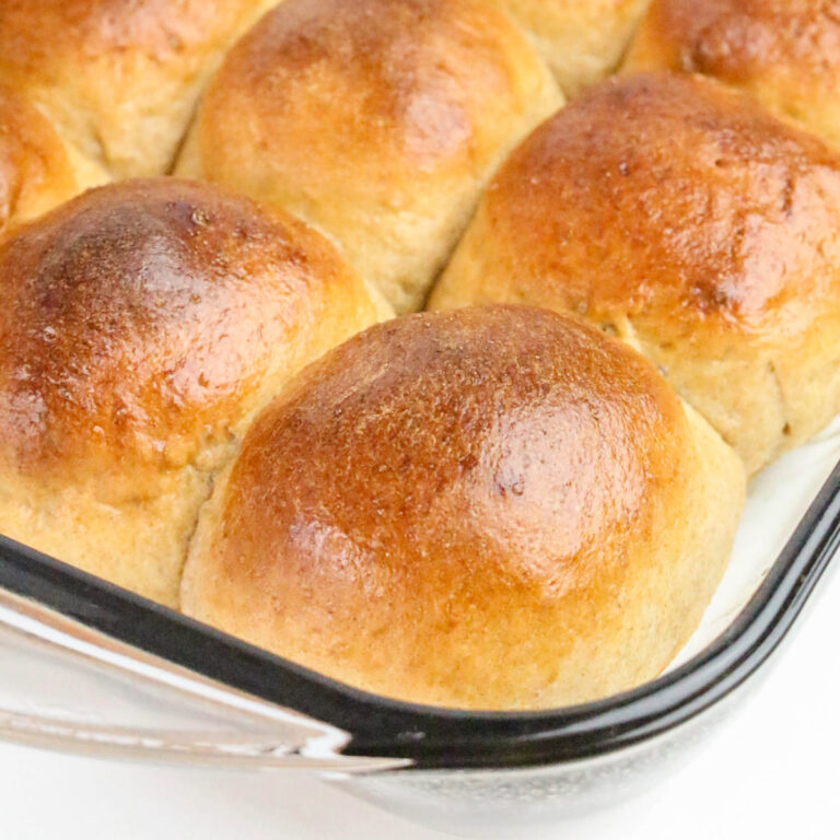 Fresh baked rolls made with whole wheat flour in a baking dish.