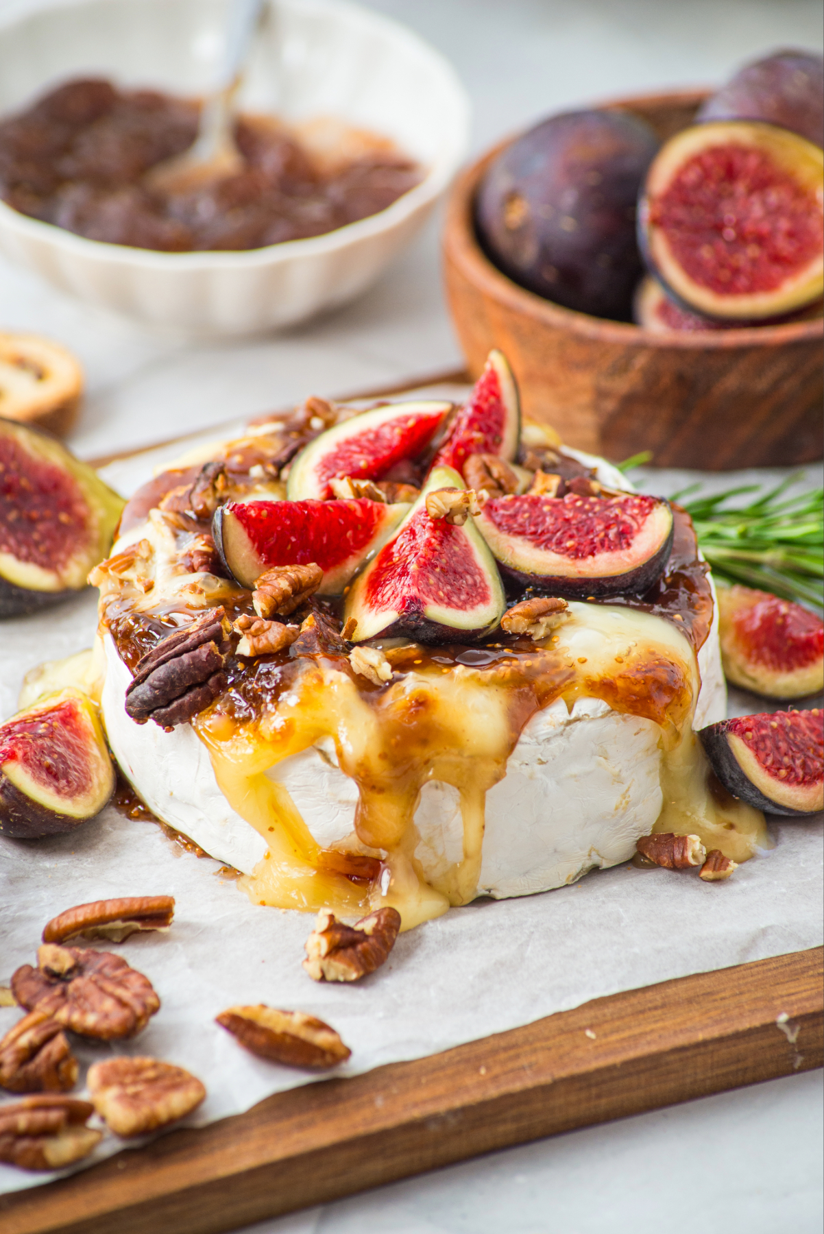A wheel of brie cheese baked in an air fryer and topped with fig jam.