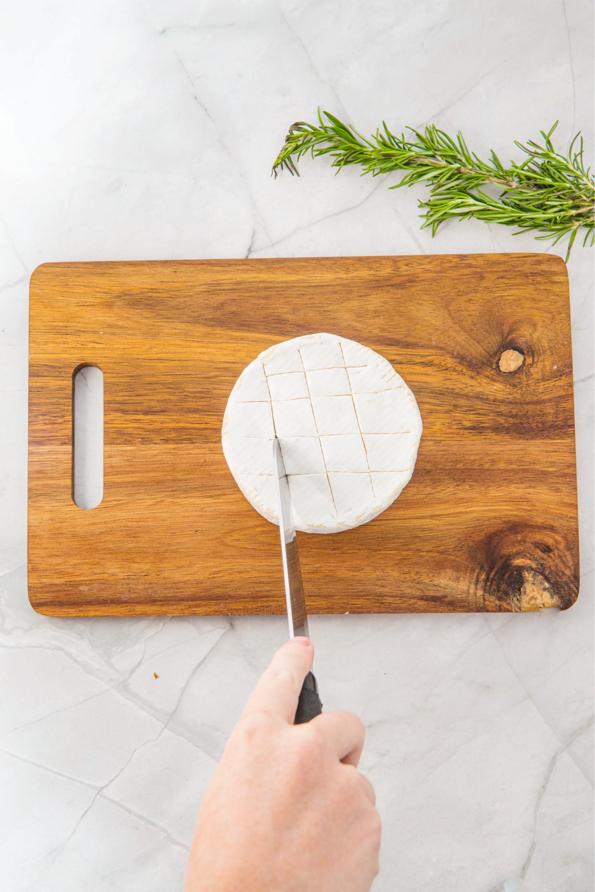 Scoring a wheel of brie.