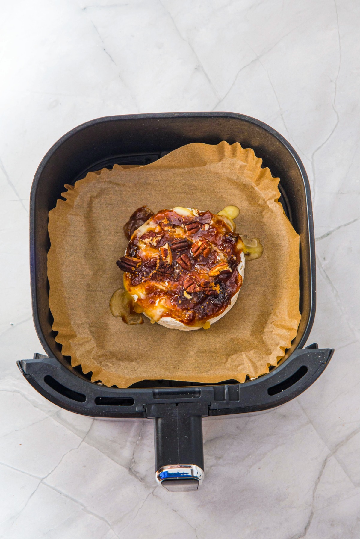 Baked brie topped with pecans and fig sauce.