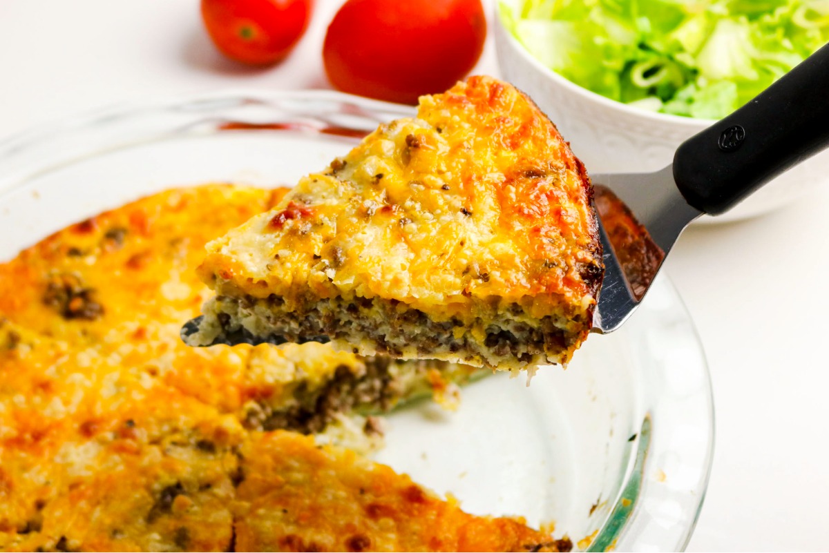 A slice of cooked hamburger pie on a spatula.