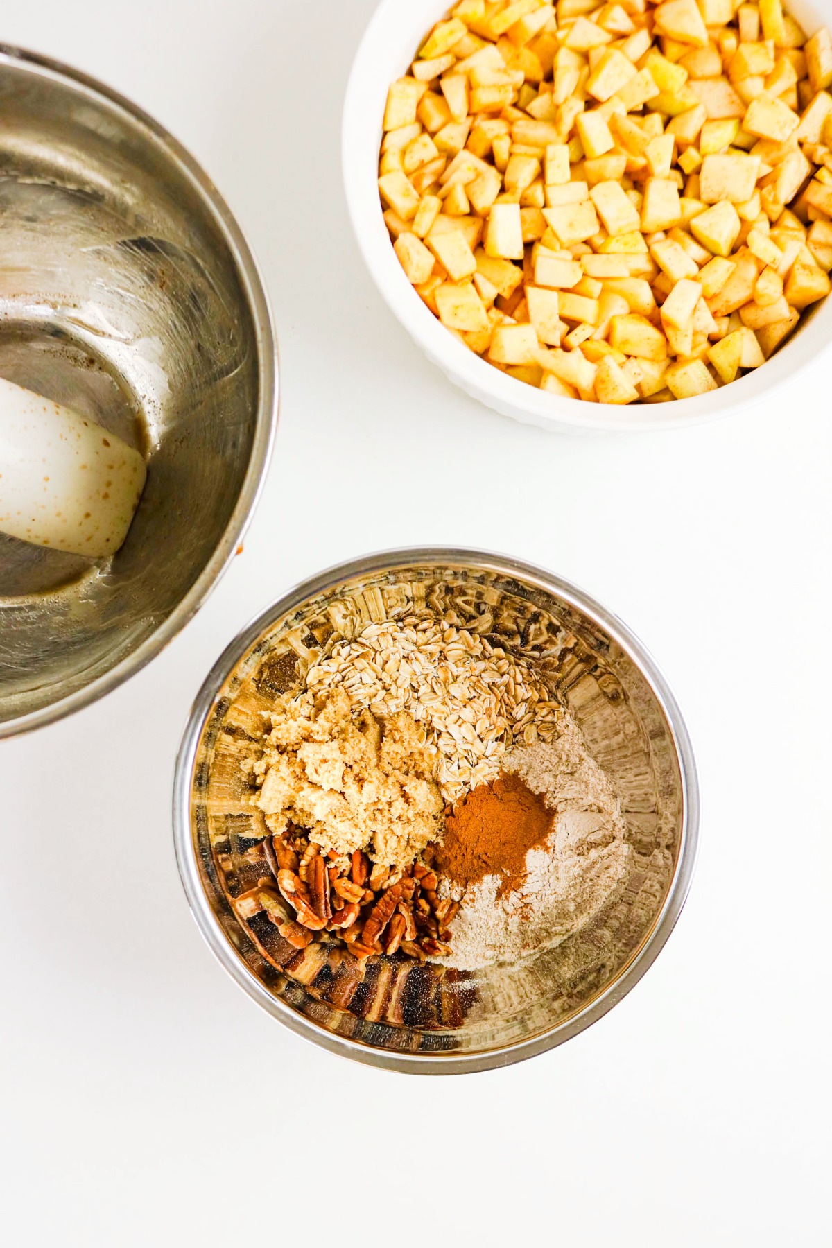 Mixed topping for apple crisp in a small mixing bowl.