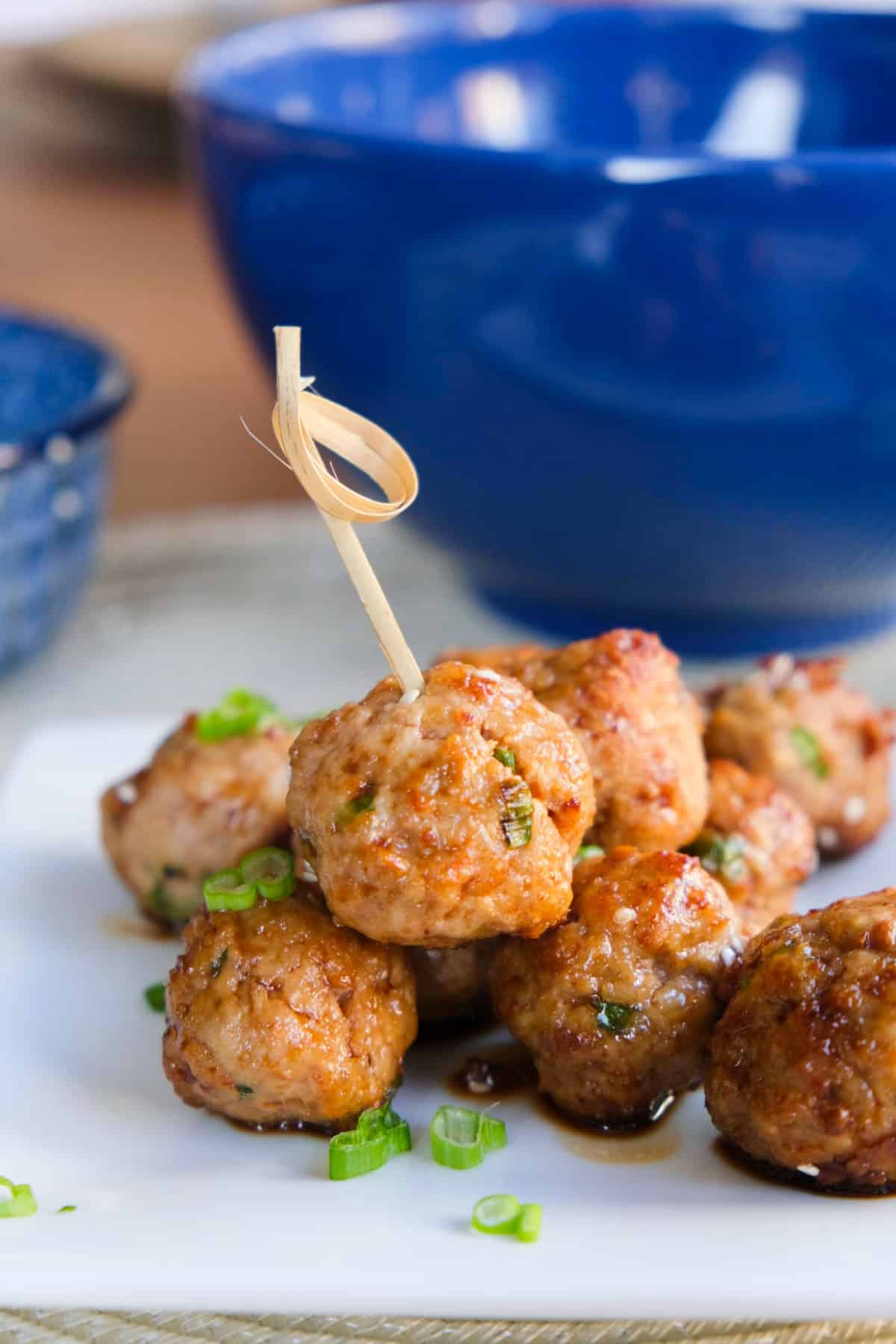 Chicken meatballs served as an appetizer with a skewer in a meatbal.