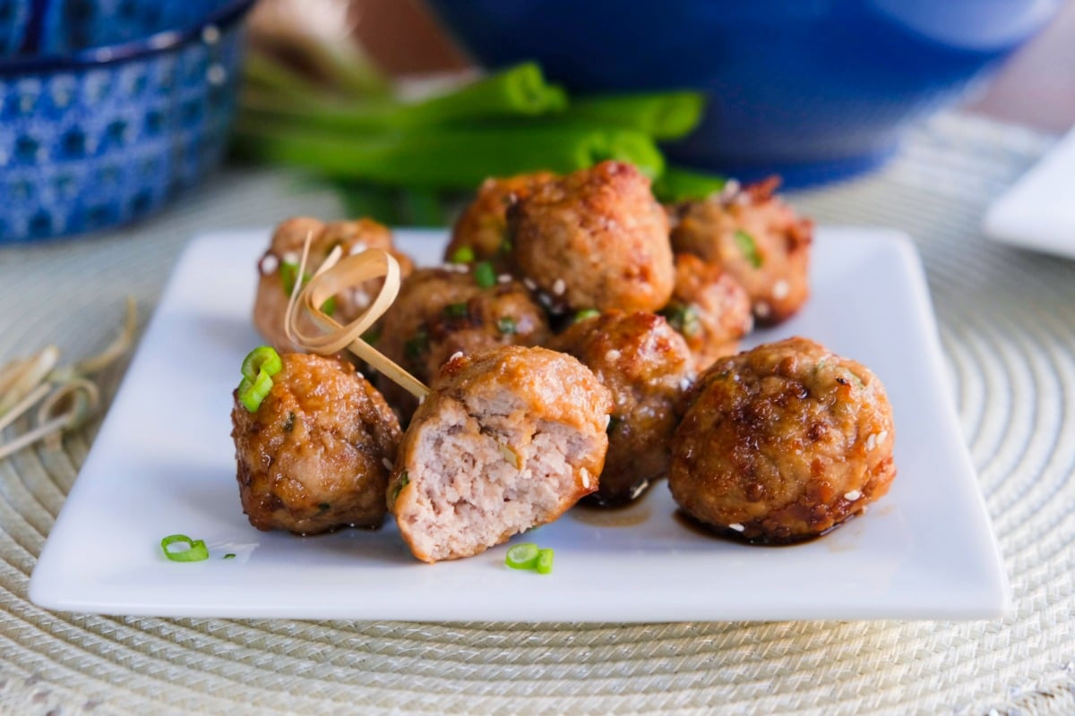 Chicken meatballs on a white square plate before eating.