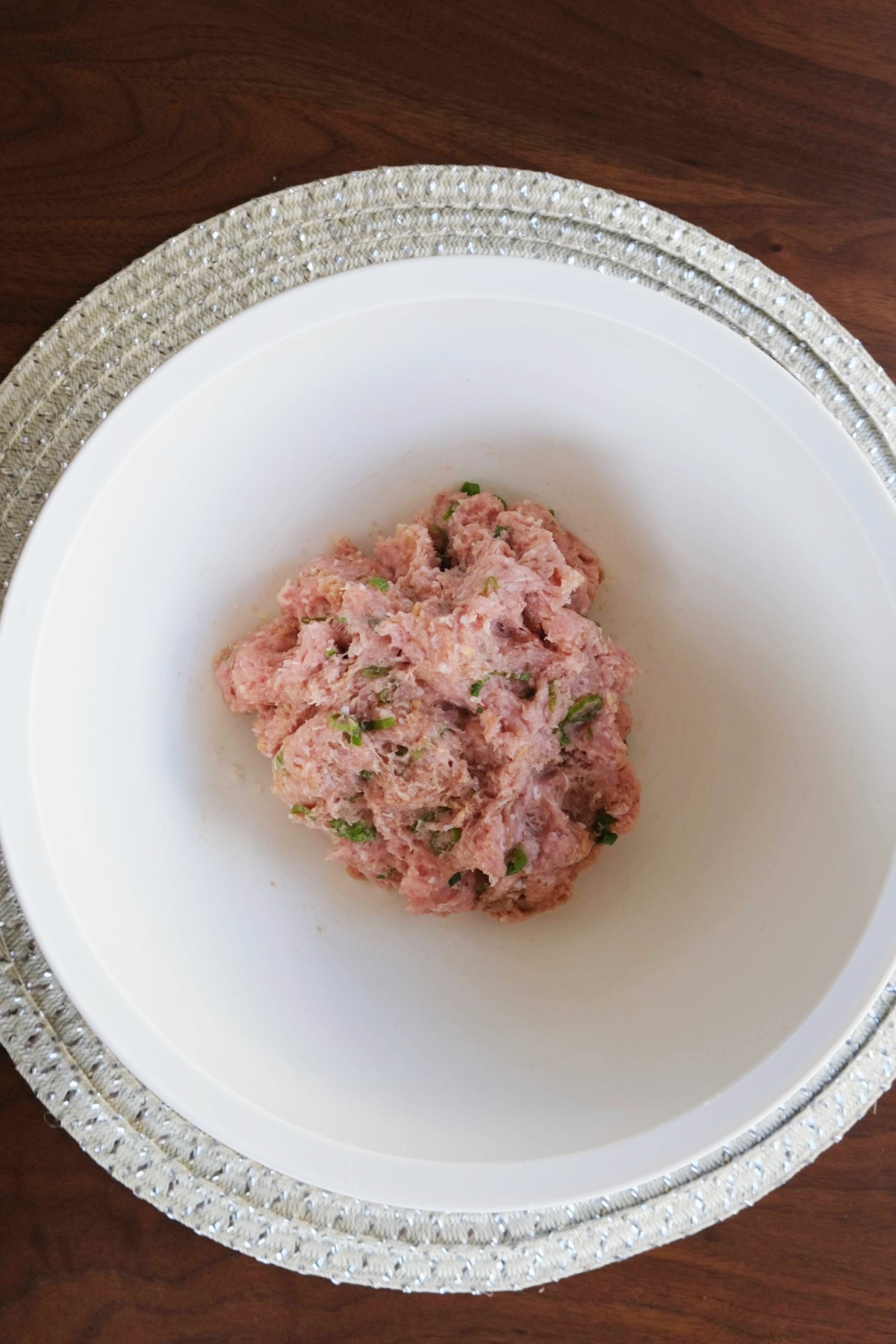 Meatball mixture in a large mixing bowl.