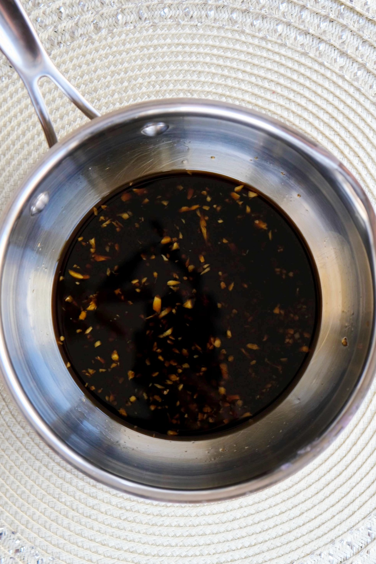 Sauce in a stainless steel saucepan simmered.