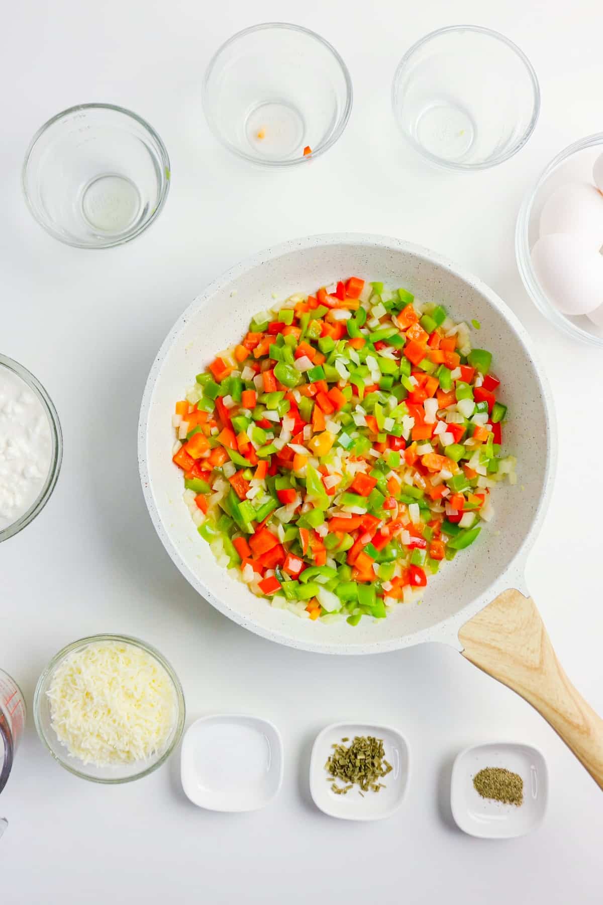 Diced red and green bell peppers in a large saute pan.