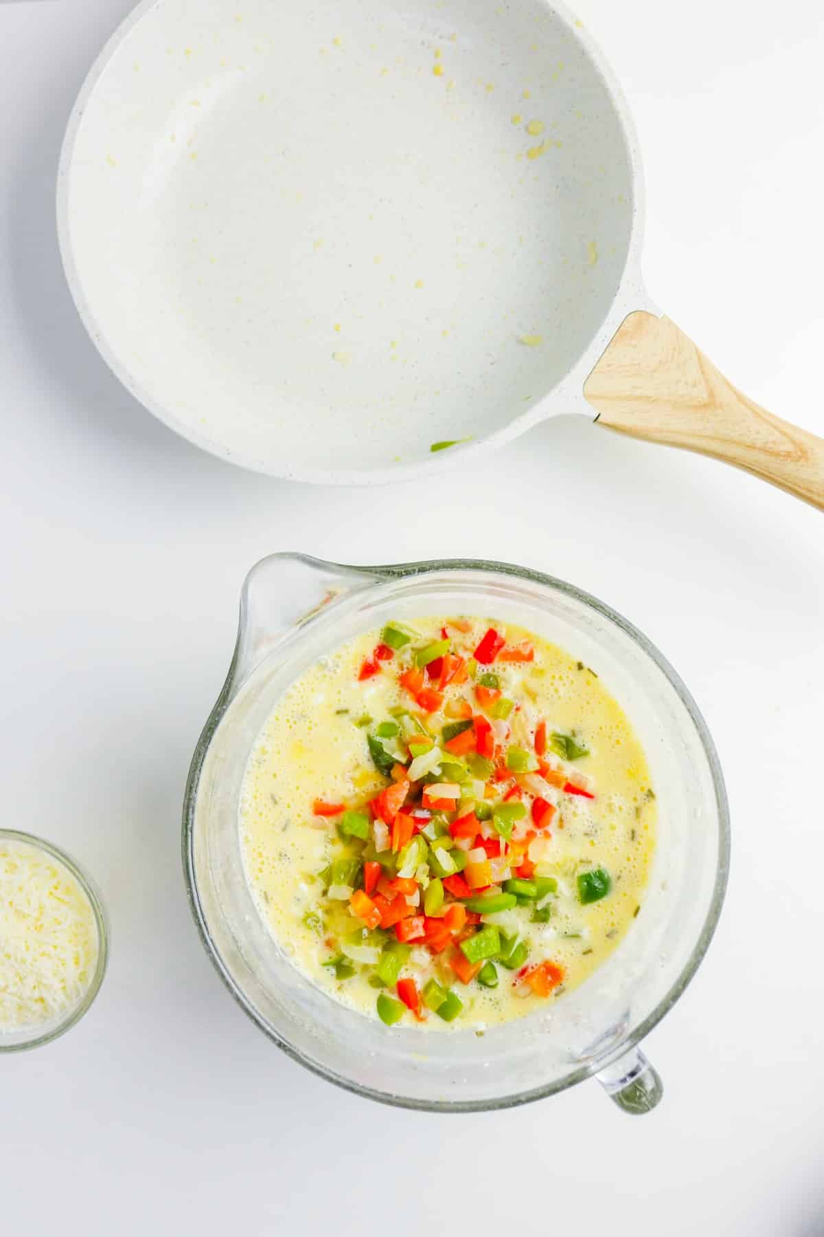 Diced vegetables folded into egg mix.