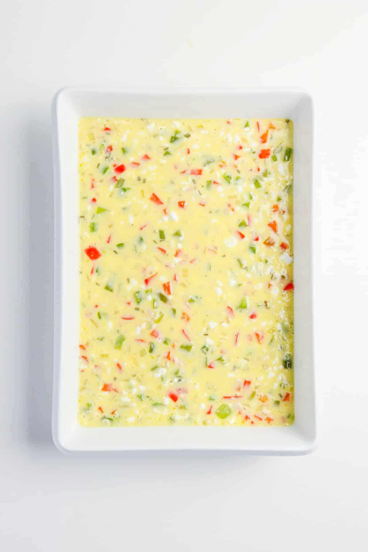 Egg mix poured into a casserole dish before baking.