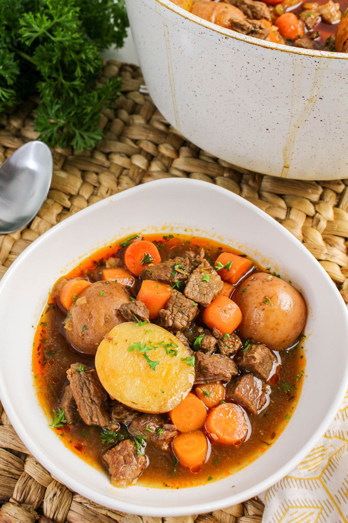 Close-up of beef brisket stew with tender beef, carrots, and potatoes.