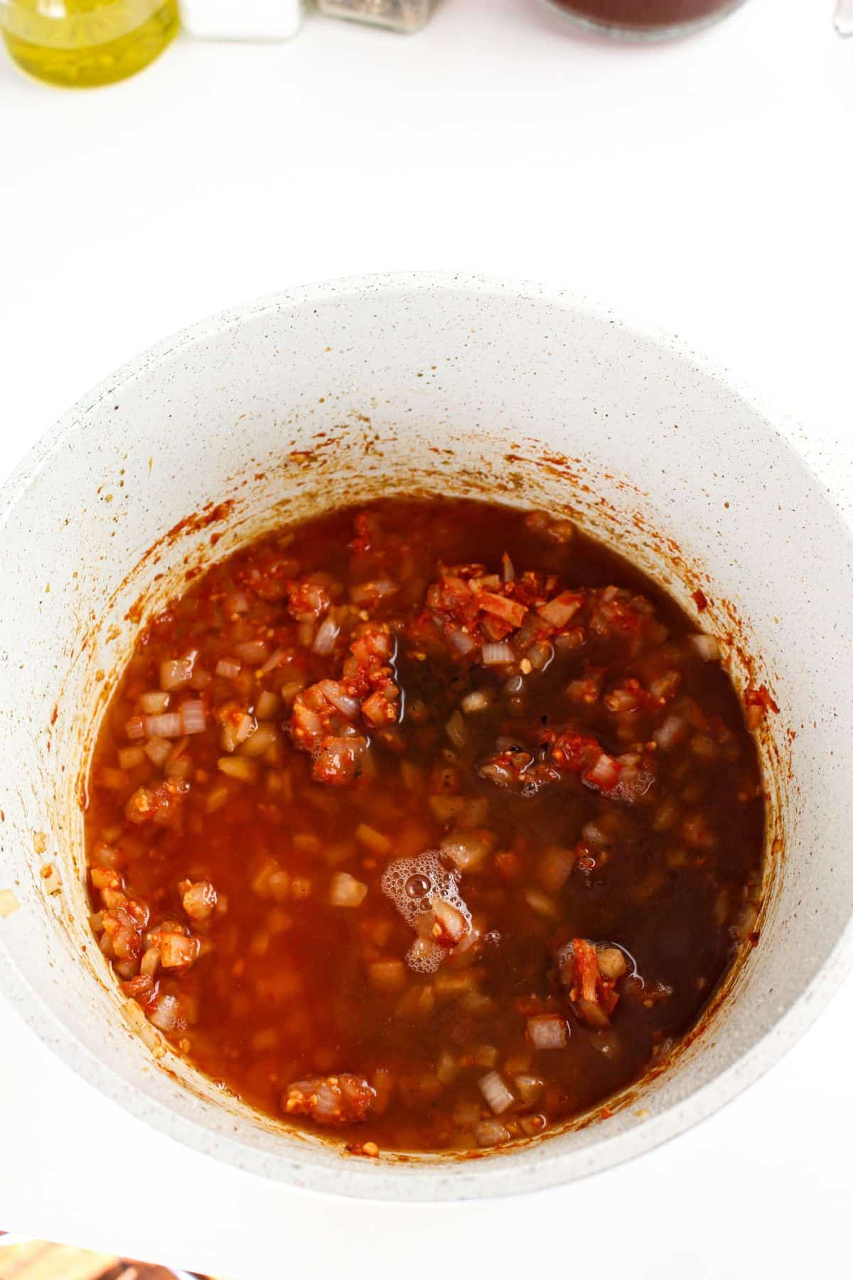 Broth and red wine in a dutch oven.