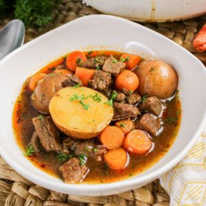 Bowl of beef brisket stew with potatoes, carrots, and rich broth.