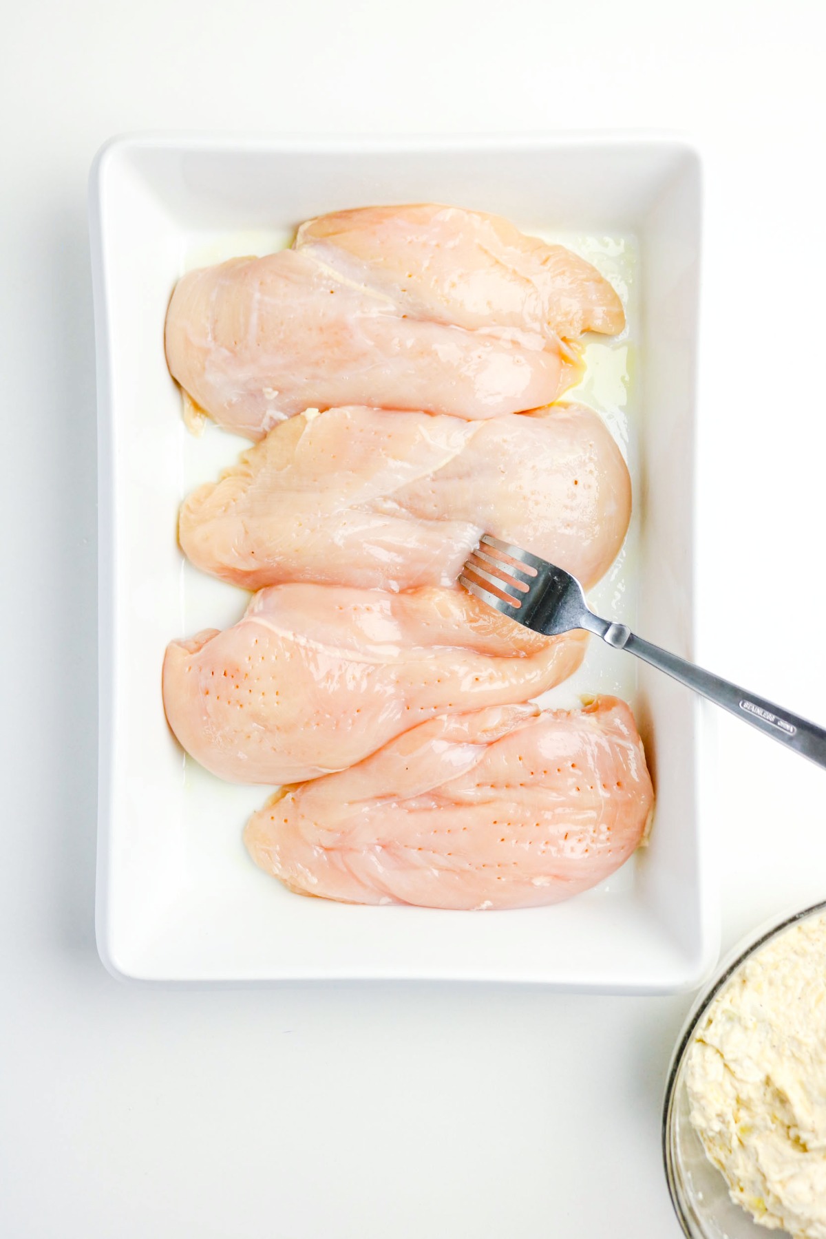 Piercing chicken with a fork.