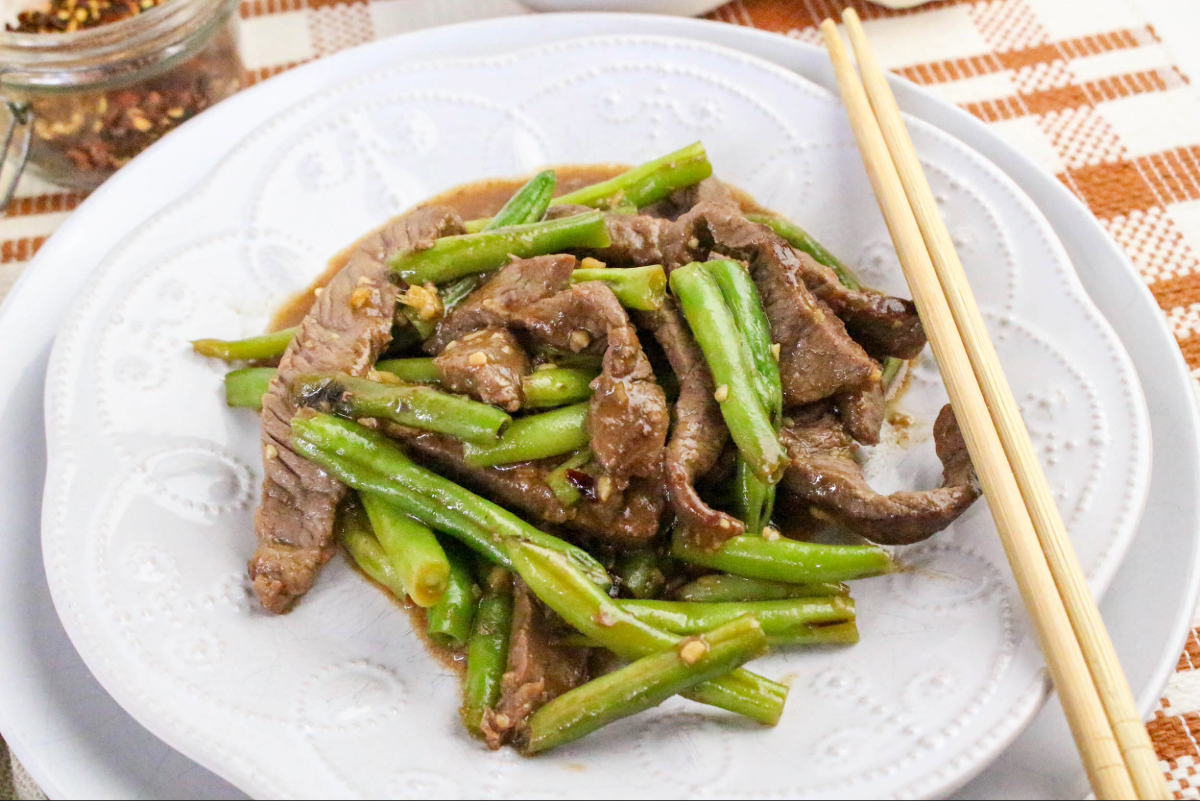 Cooked beef on a white plate.