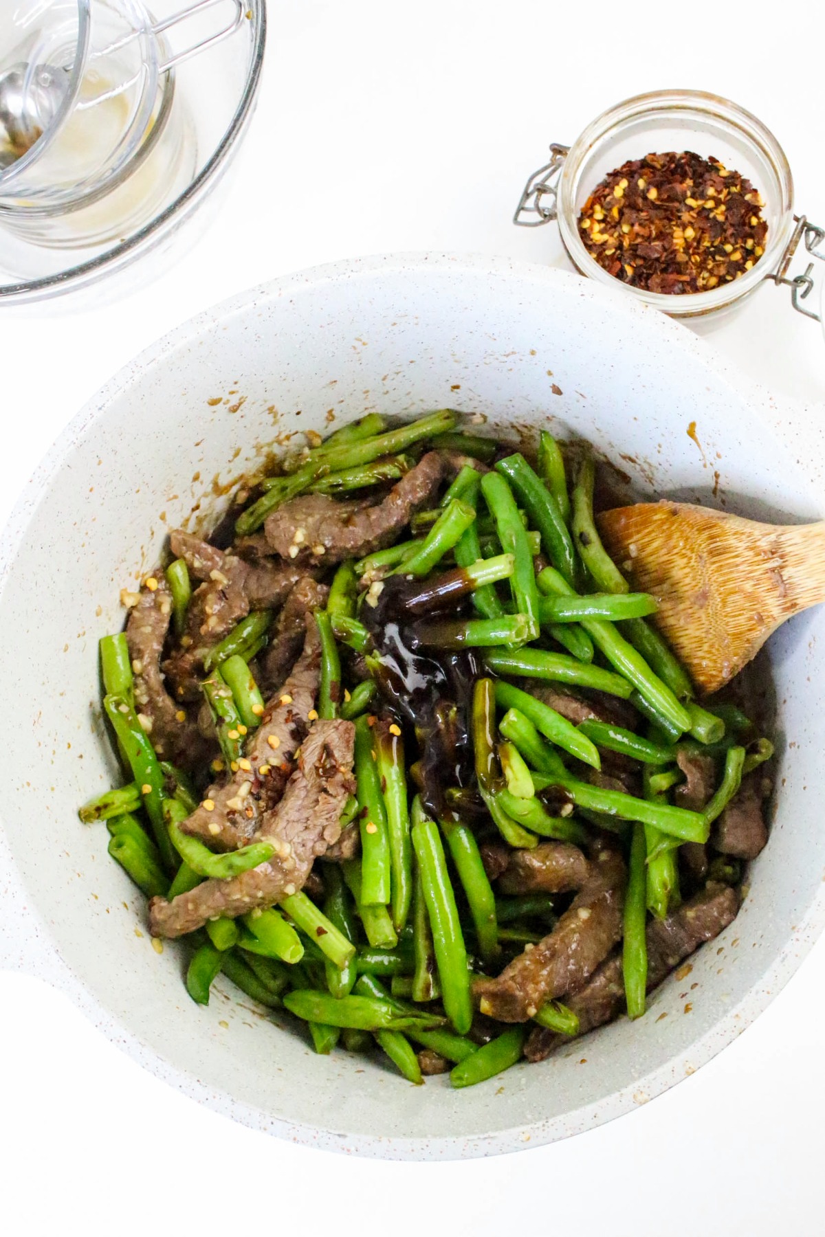 Green beans mixed with beef and additional sauce.