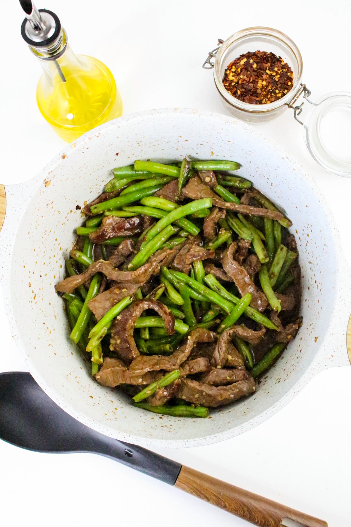 Beef and green beans cooked in a large skillet.