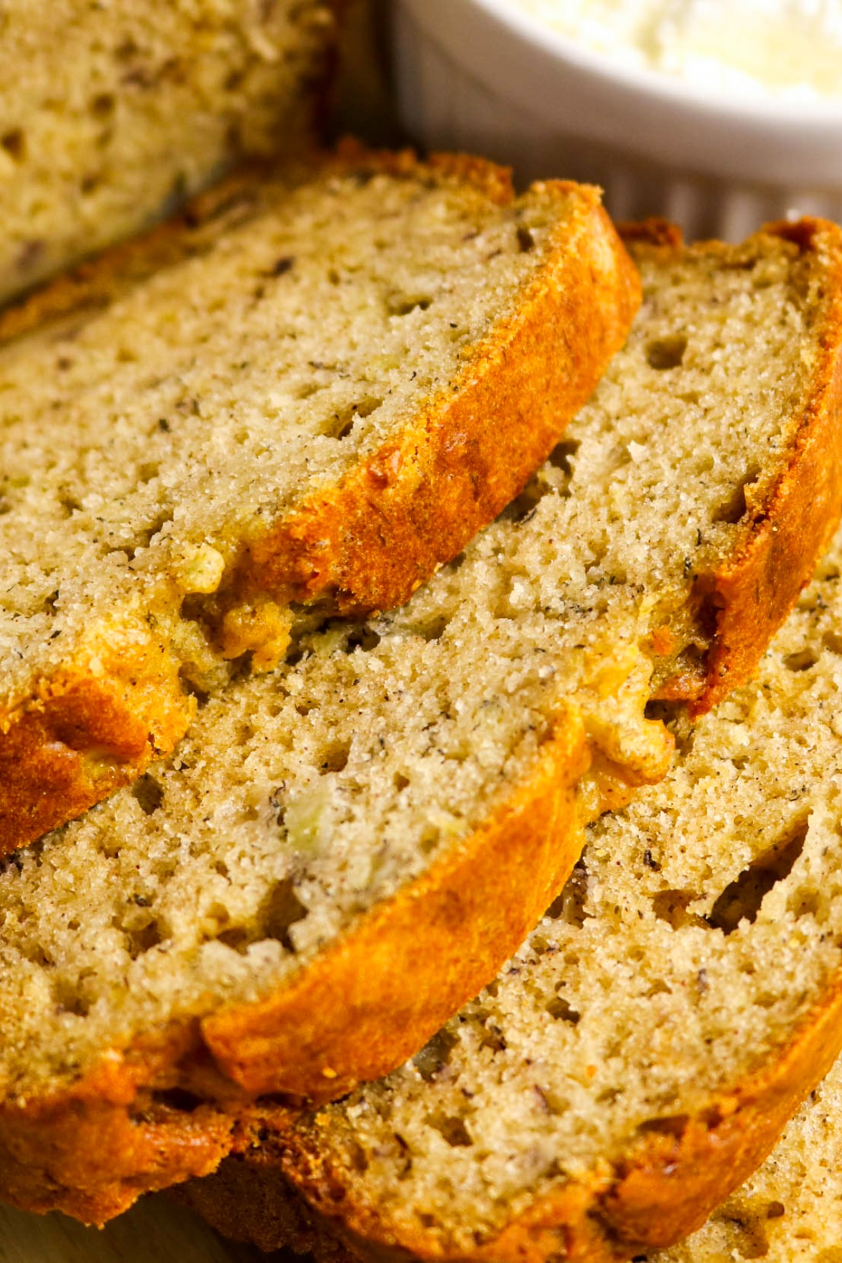 Sliced banana bread on a cutting board.