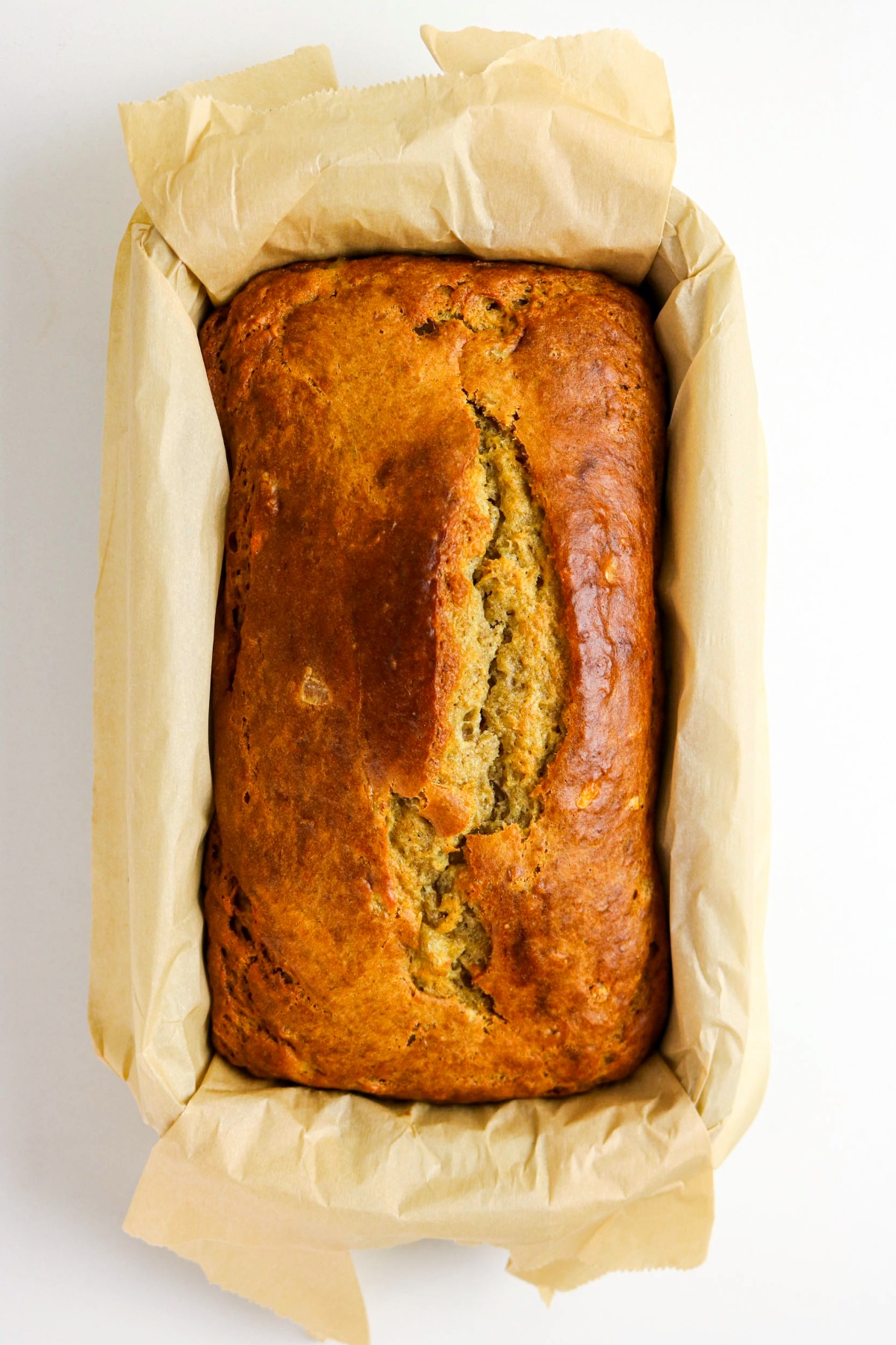 Baked cottage cheese banana bread in a parchment lined loaf pan.