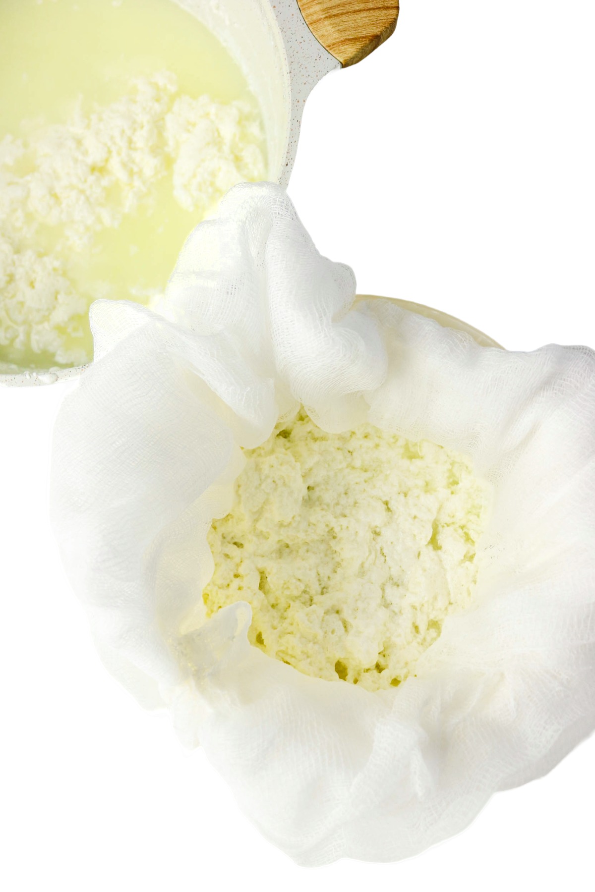 Draining cottage cheese in cheesecloth over a bowl.