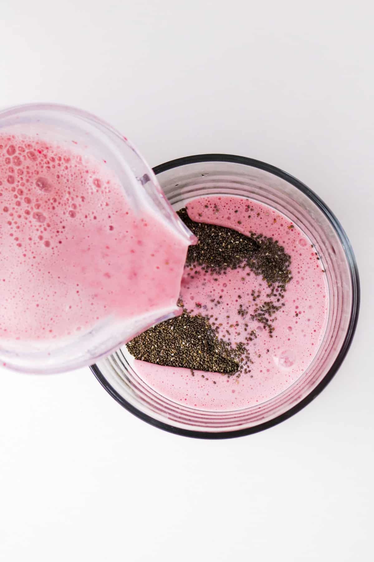 Pouring blended strawberries in a mixing bowl.