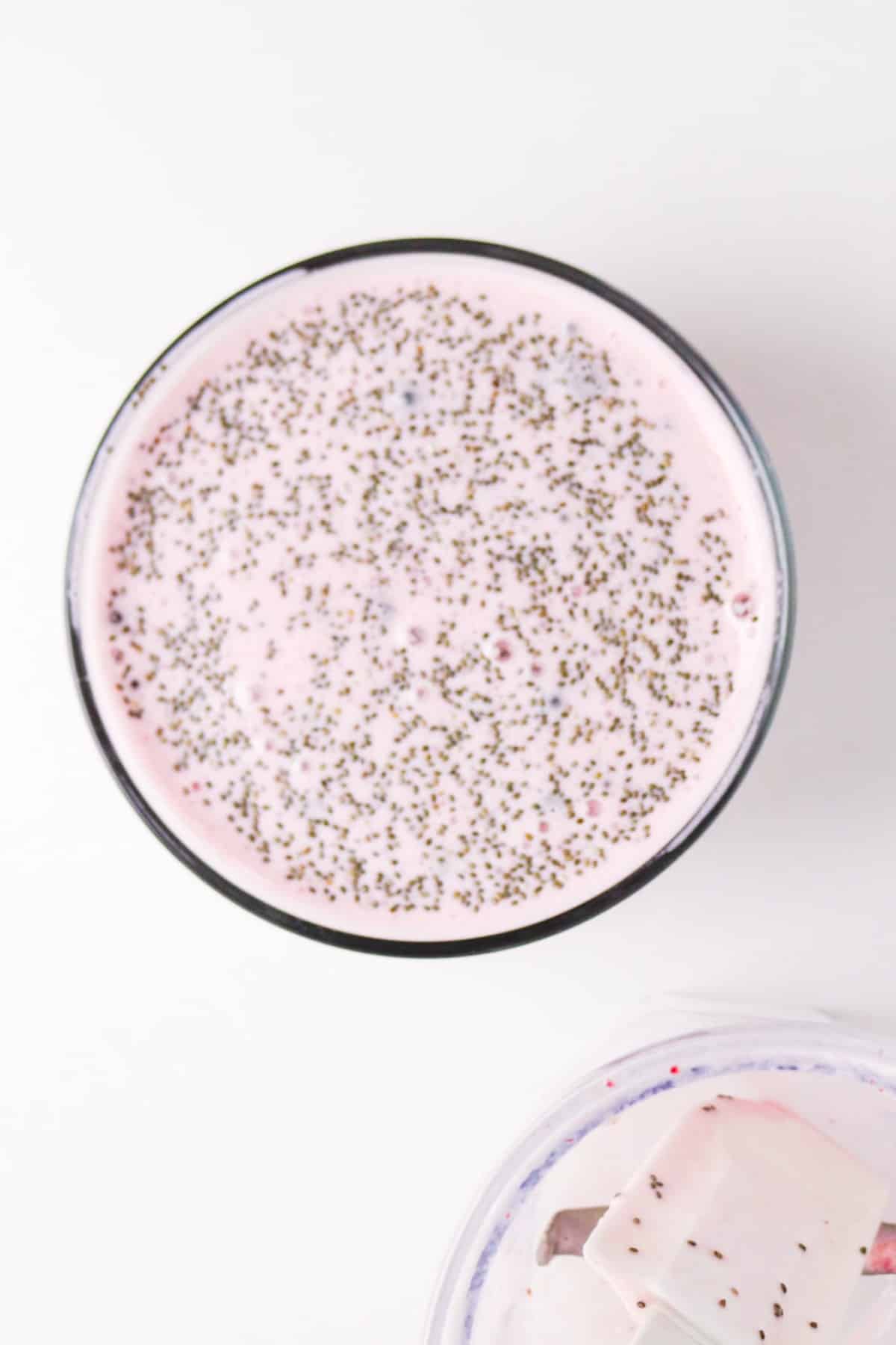 A clear bowl with strawberry chia pudding before serving.