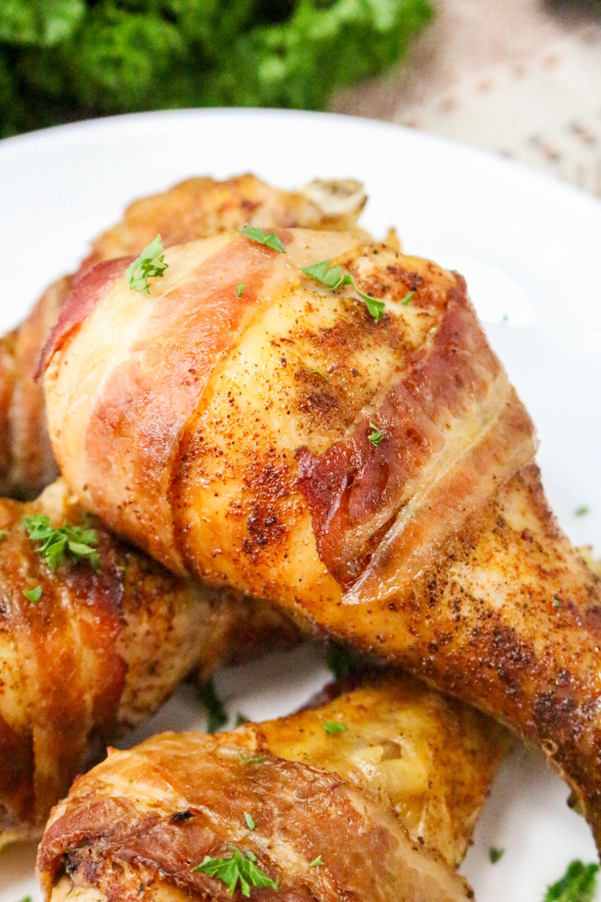 close view of cooked chicken wrapped in bacon.