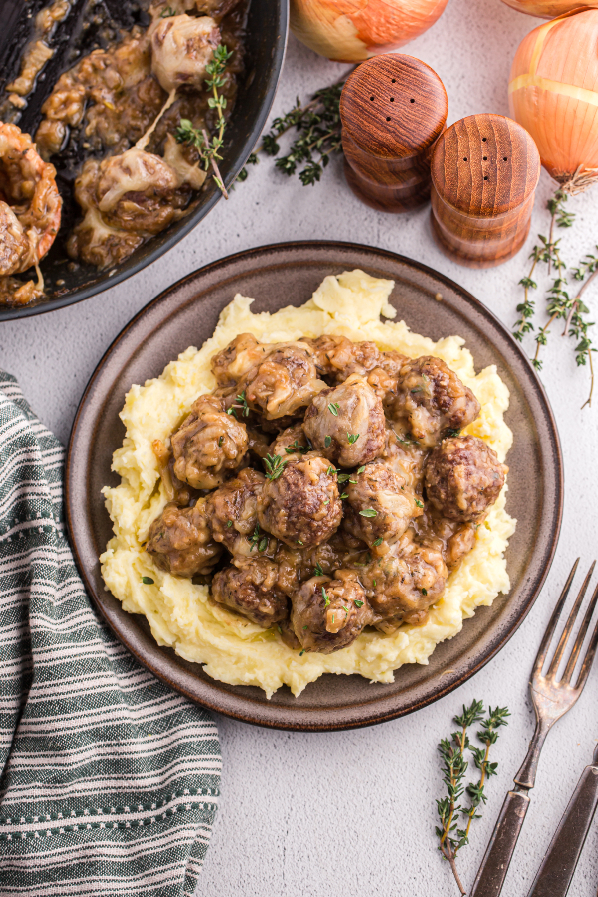 Top view of a plateful of meatballs with mashed potatoes.