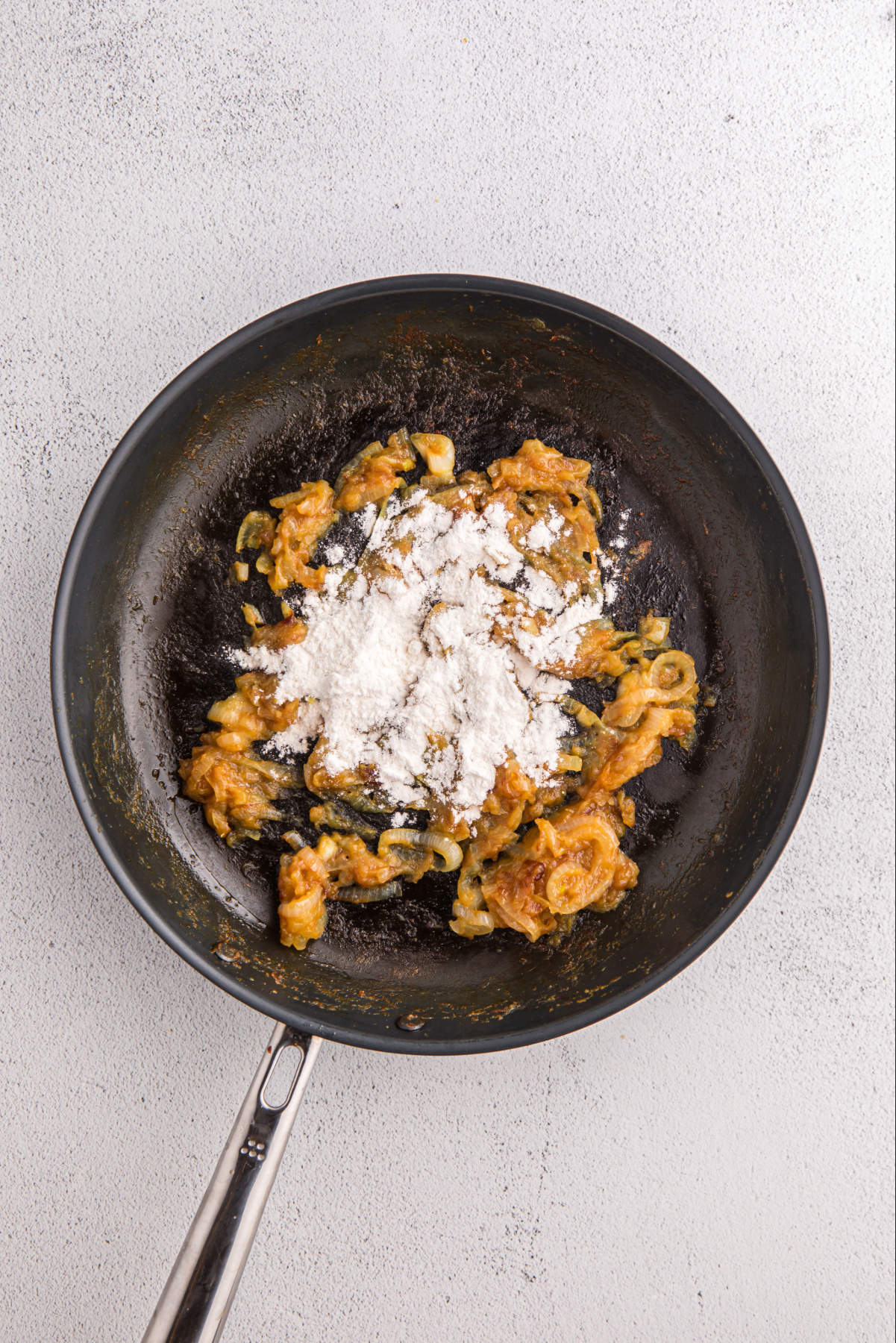 Flour over cooked onions.