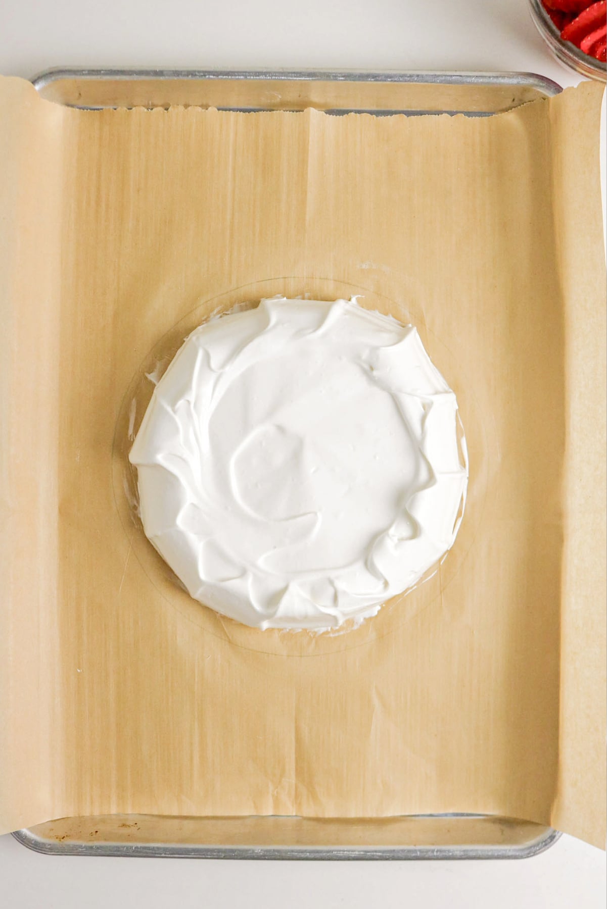 meringue shell on a parchment lined baking sheet before baking.
