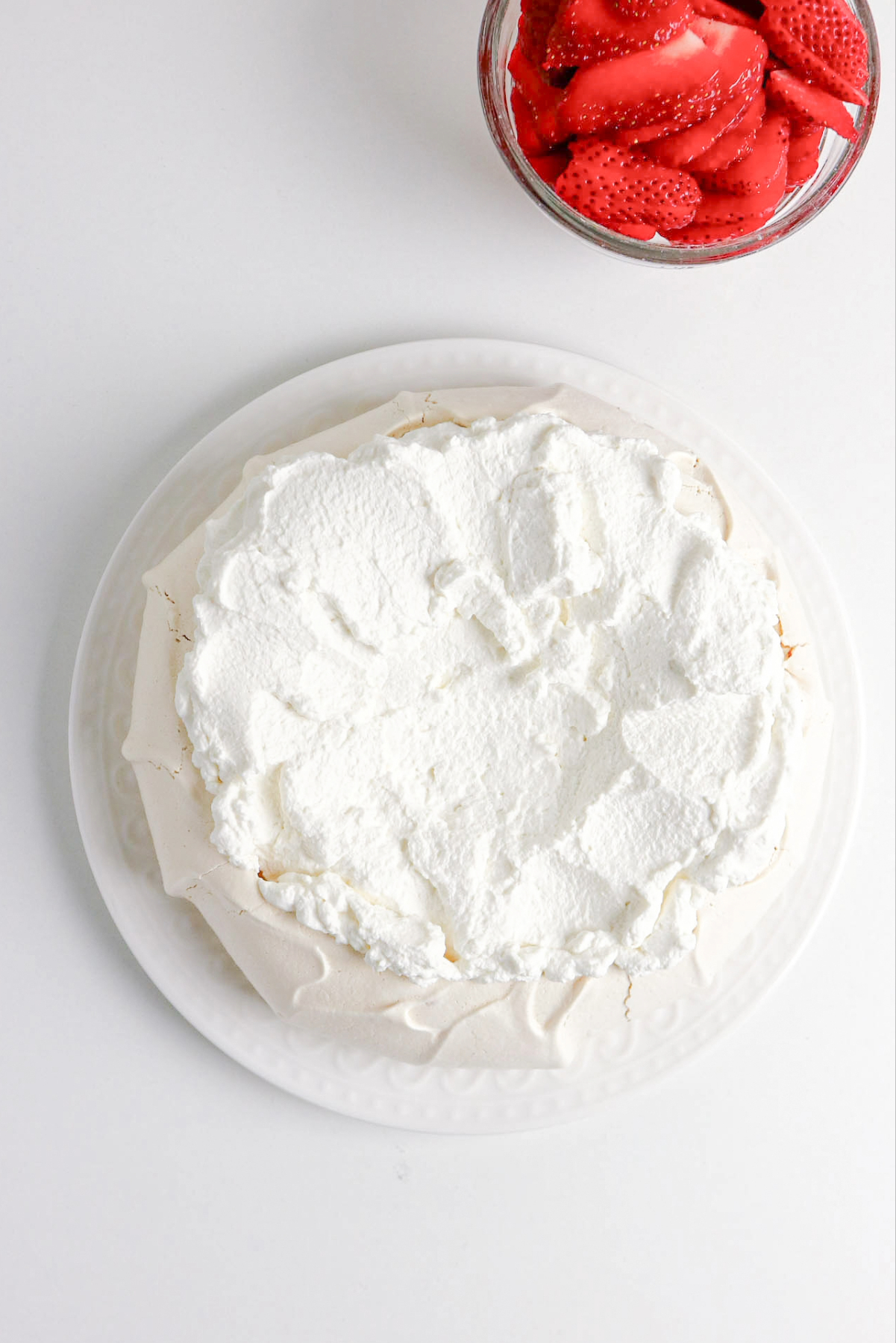 whipped cream added to baked pavlova shell.