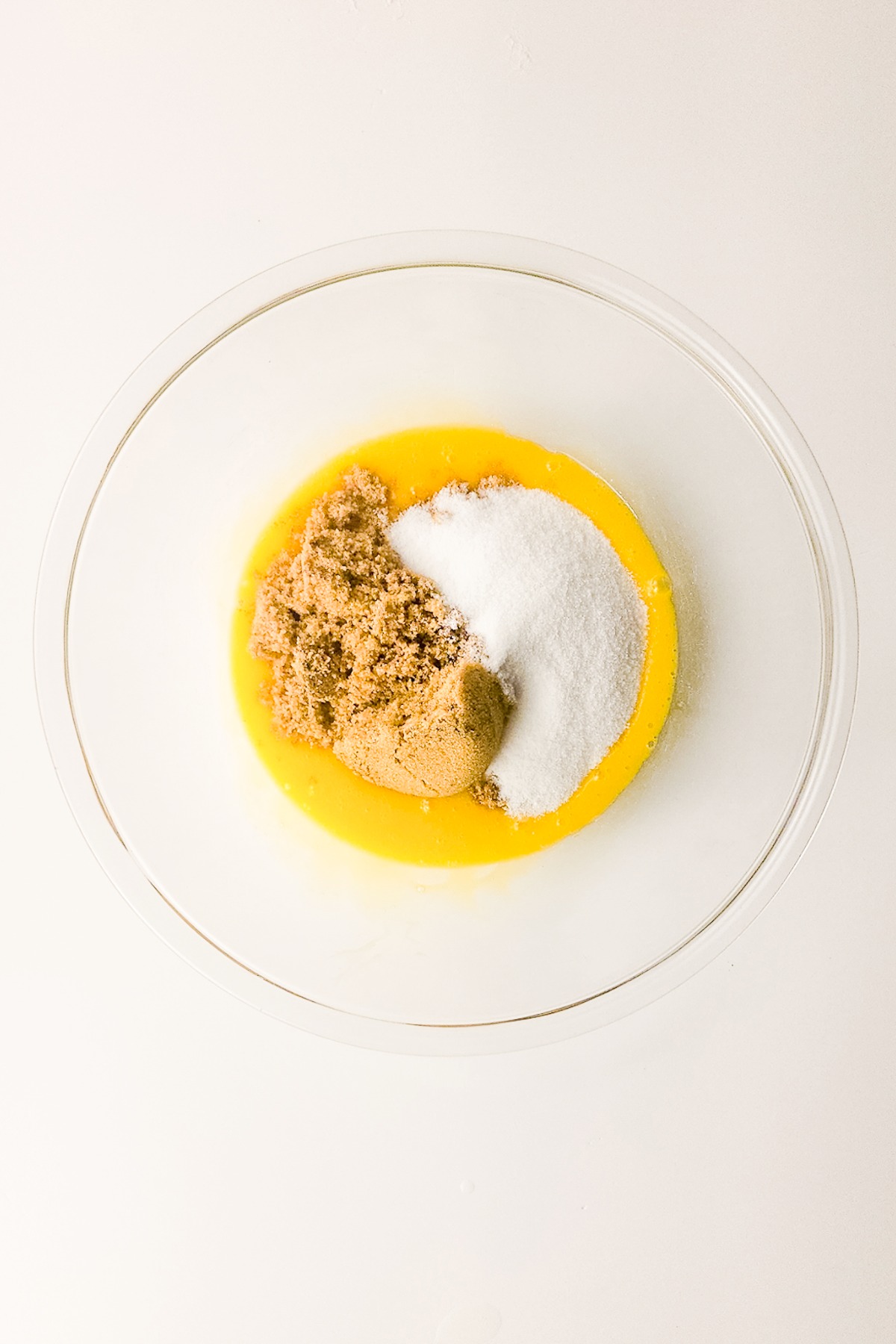 egg yokes with sugar in a mixing bowl.