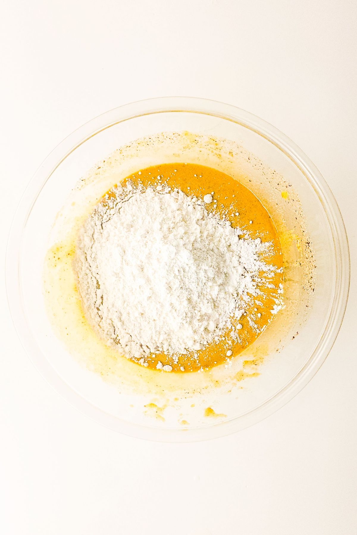 wet and dry cake ingredients in a mixing bowl before combining.