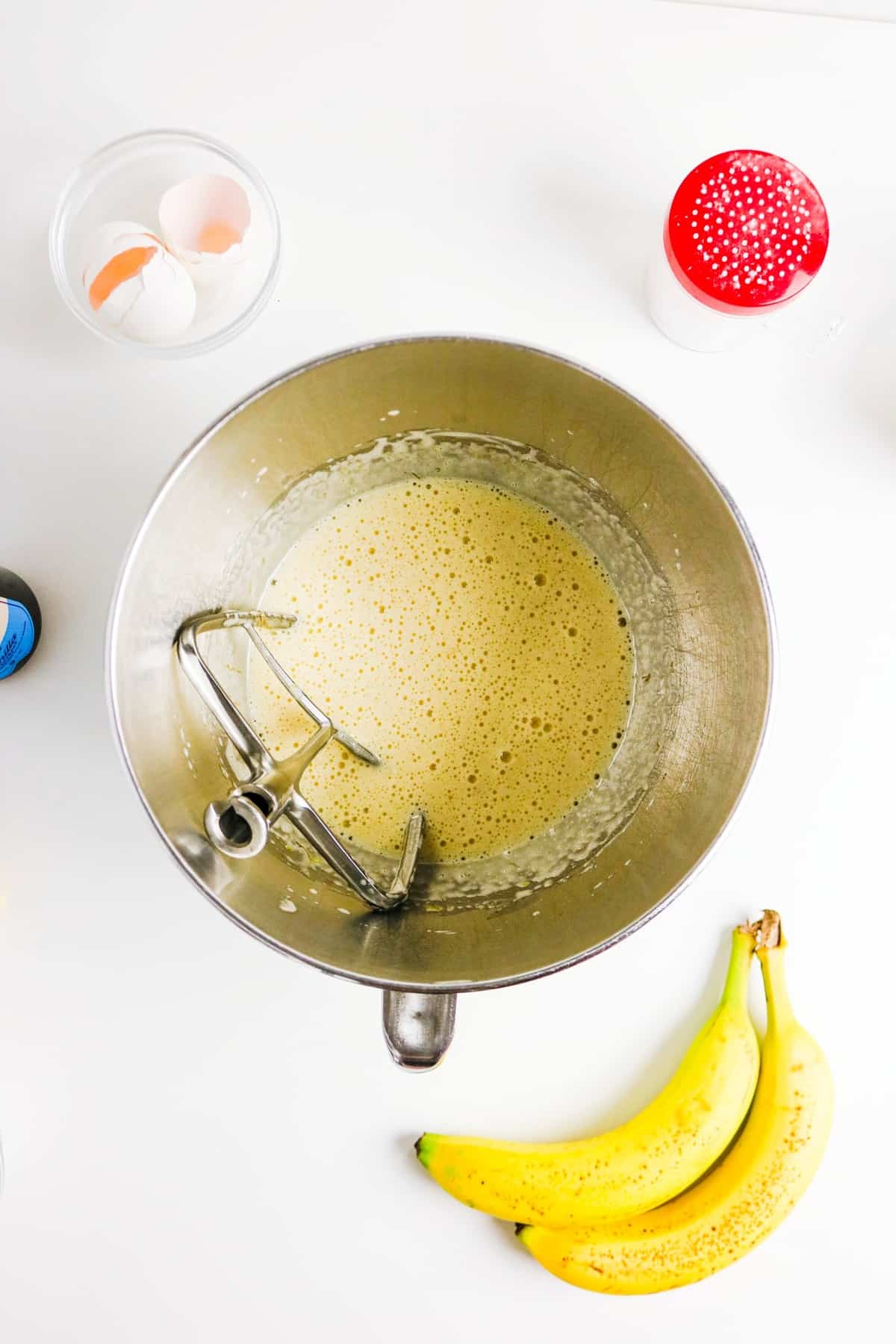 Wet cake ingredients in a silver mixing bowl.