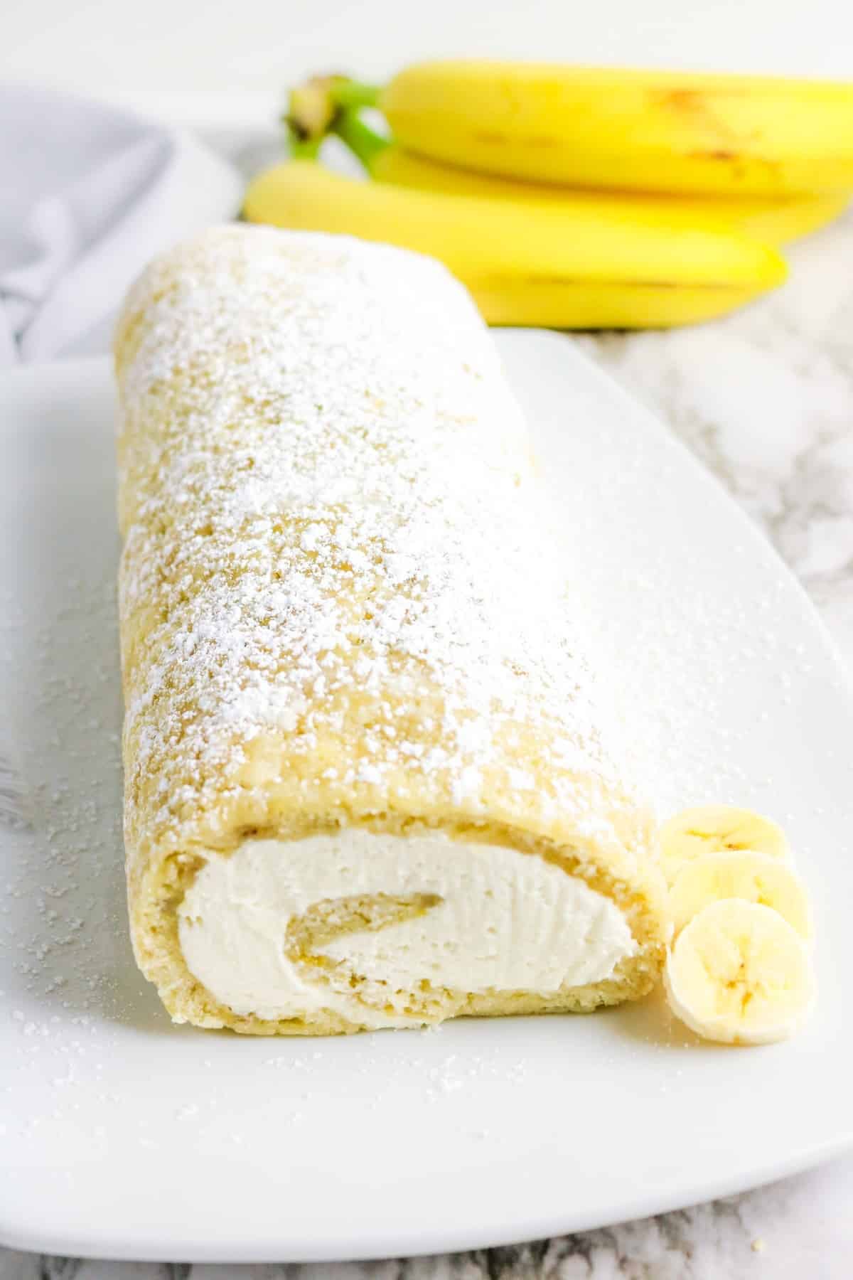 A whole cake roll on a serving platter.