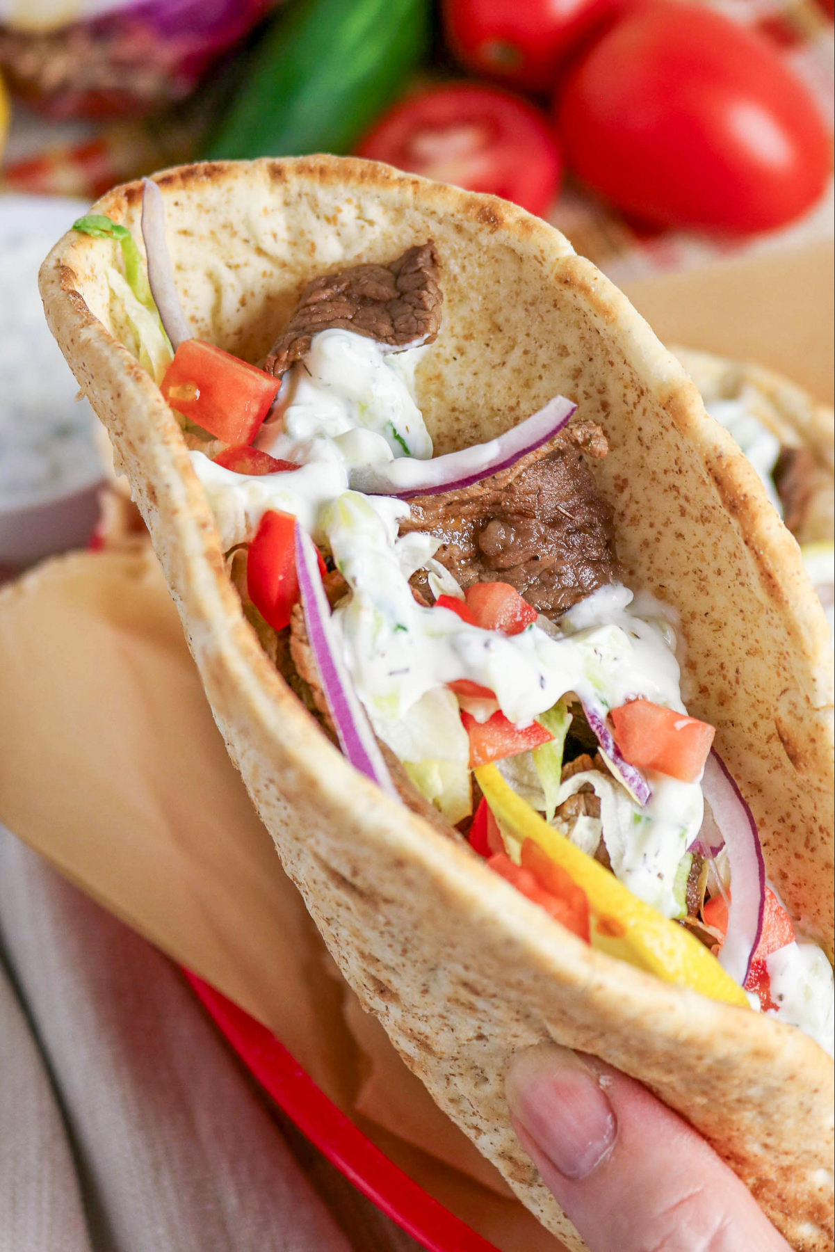Holding a gyro wrap.