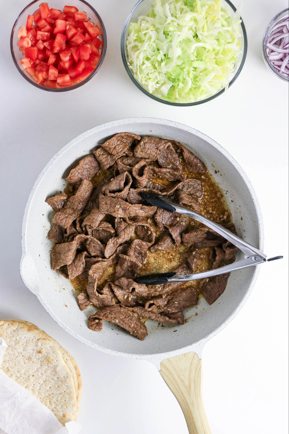 Cooking beef in a skillet.
