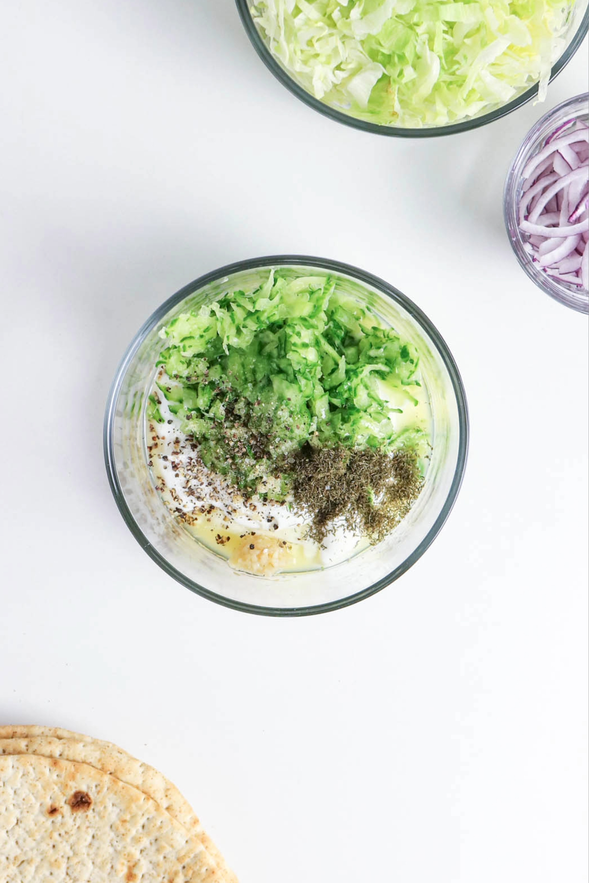 Yogurt sauce mix in a clear mixing bowl.