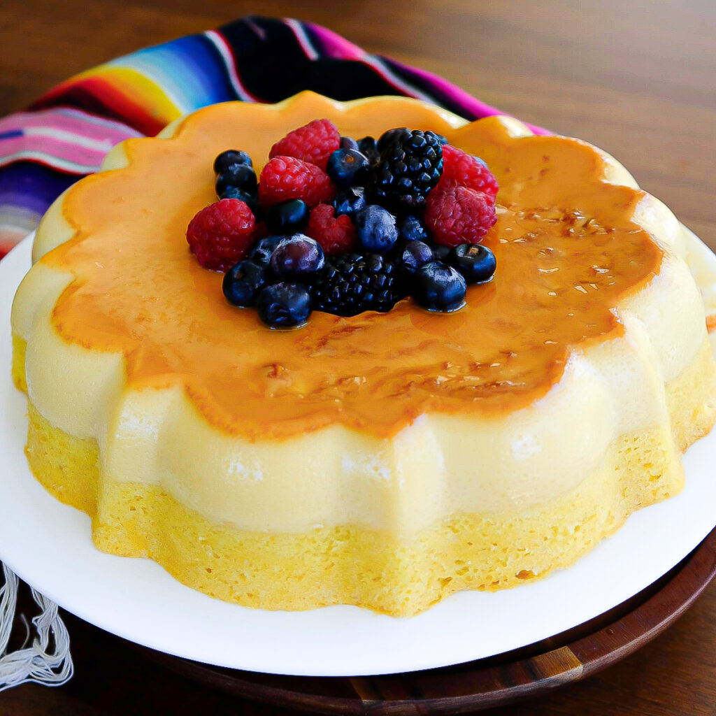 Vanilla flan cake with fresh berries in the center.