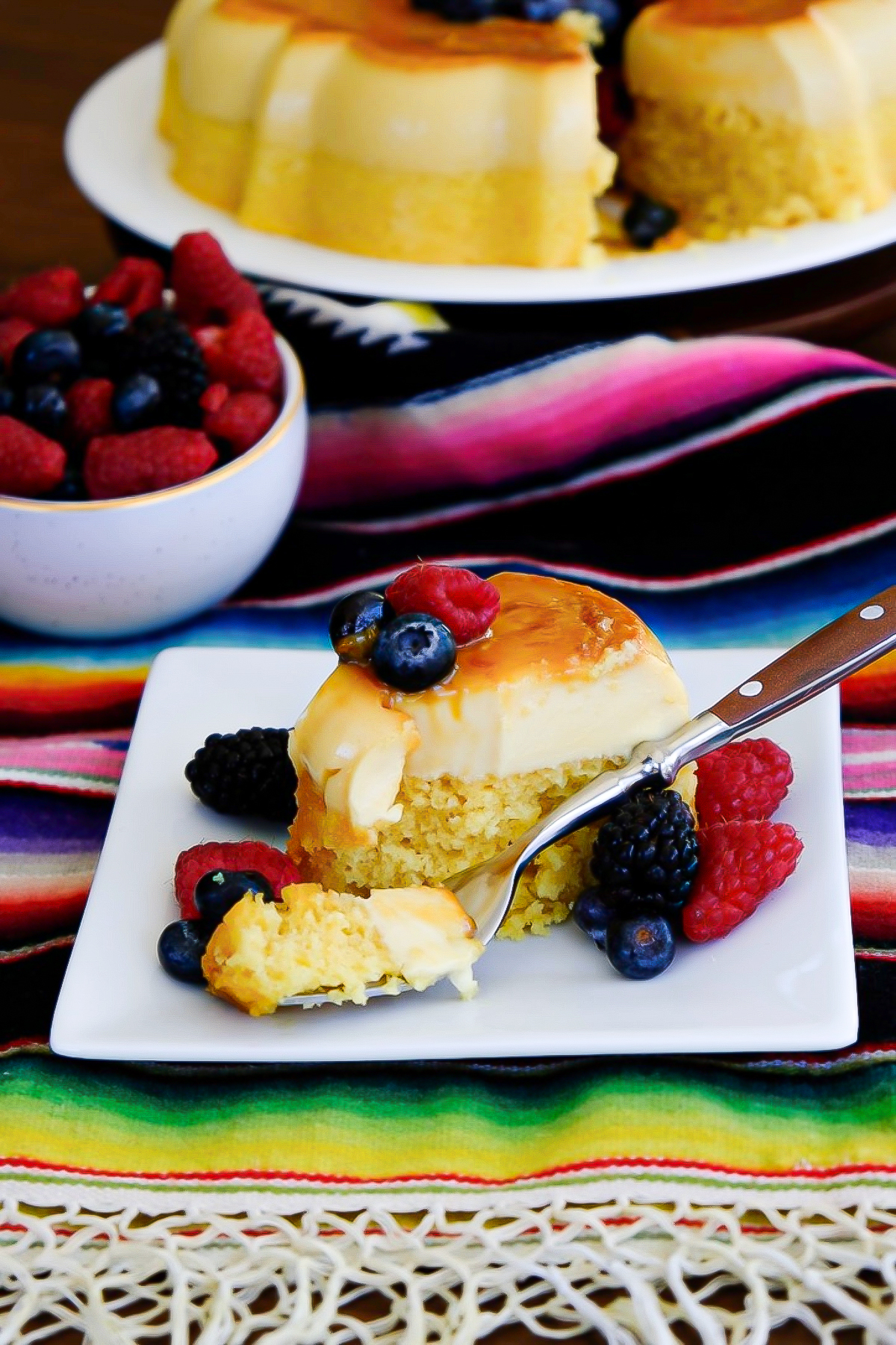 A slice of flan cake with a fork ready to take a bite.