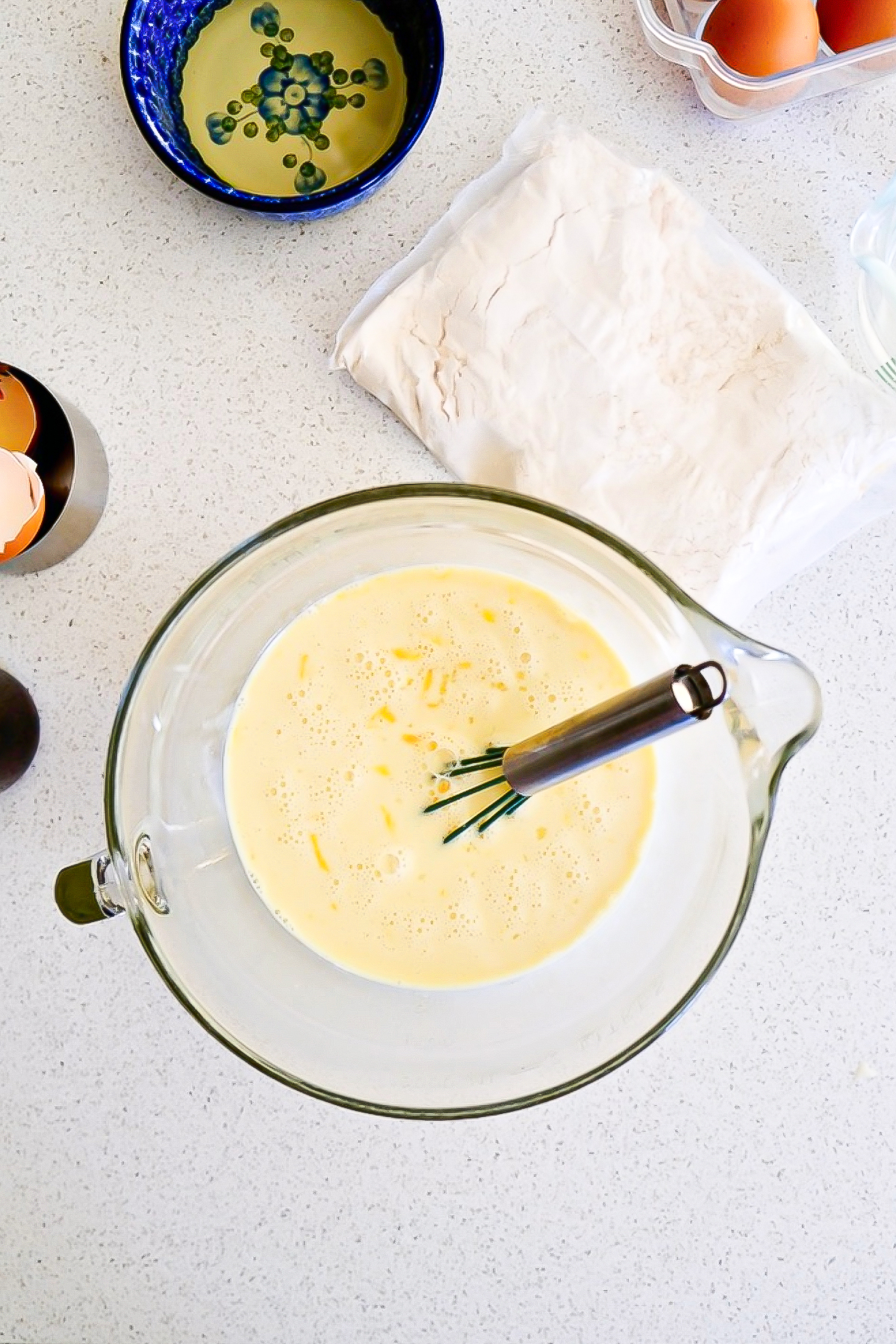 Ingredients for flan in a mixing bowl.