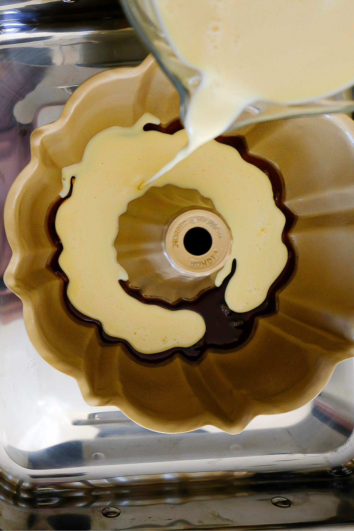 Flan mix poured over caramel in a bundt pan.